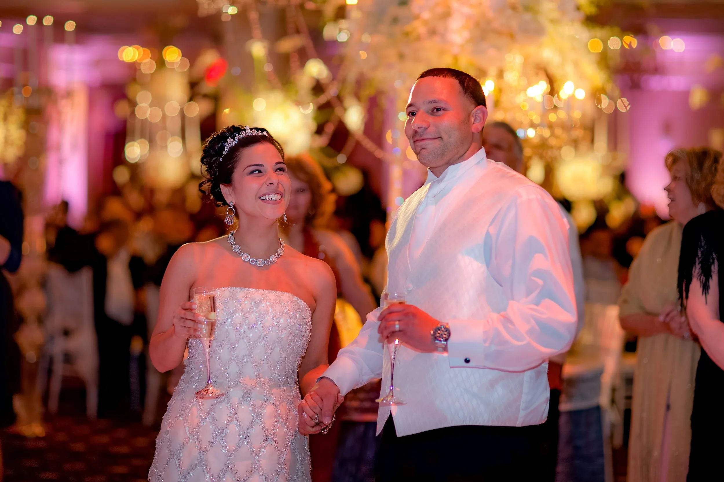 Bride and groom listening attentively to a heartfelt toast during the reception.