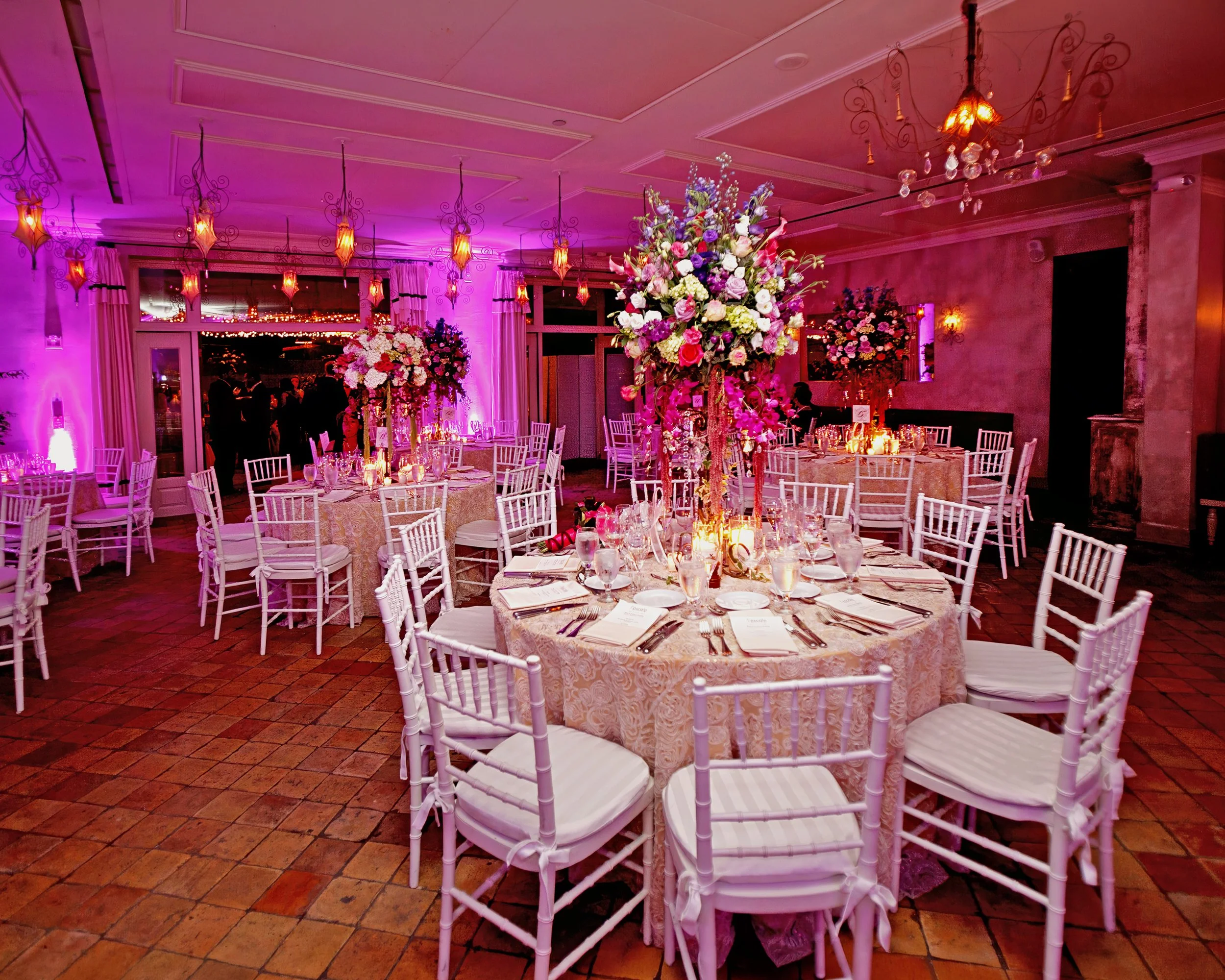 Decor and table settings in the ballroom at Delamar Greenwich Harbor, ready for a wedding reception.