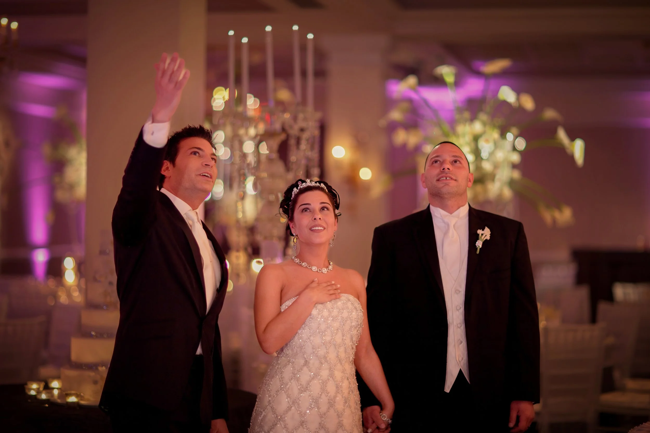 David Tutera showcases the ballroom decor to a delighted bride and groom at The Palace at Somerset Park.