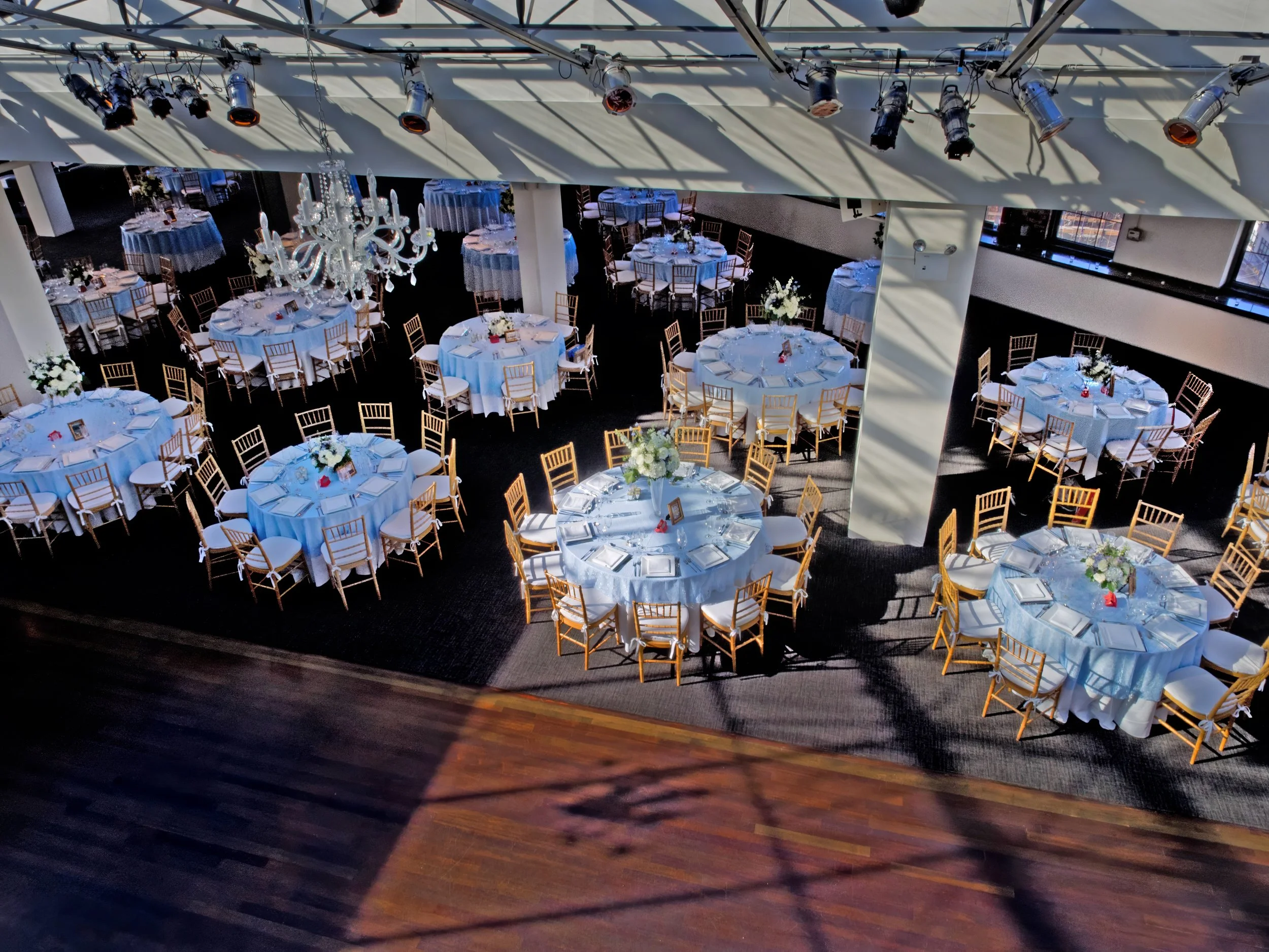 Bird’s-eye view of the Tribeca Rooftop reception space fully decorated with tables, florals, and elegant lighting.