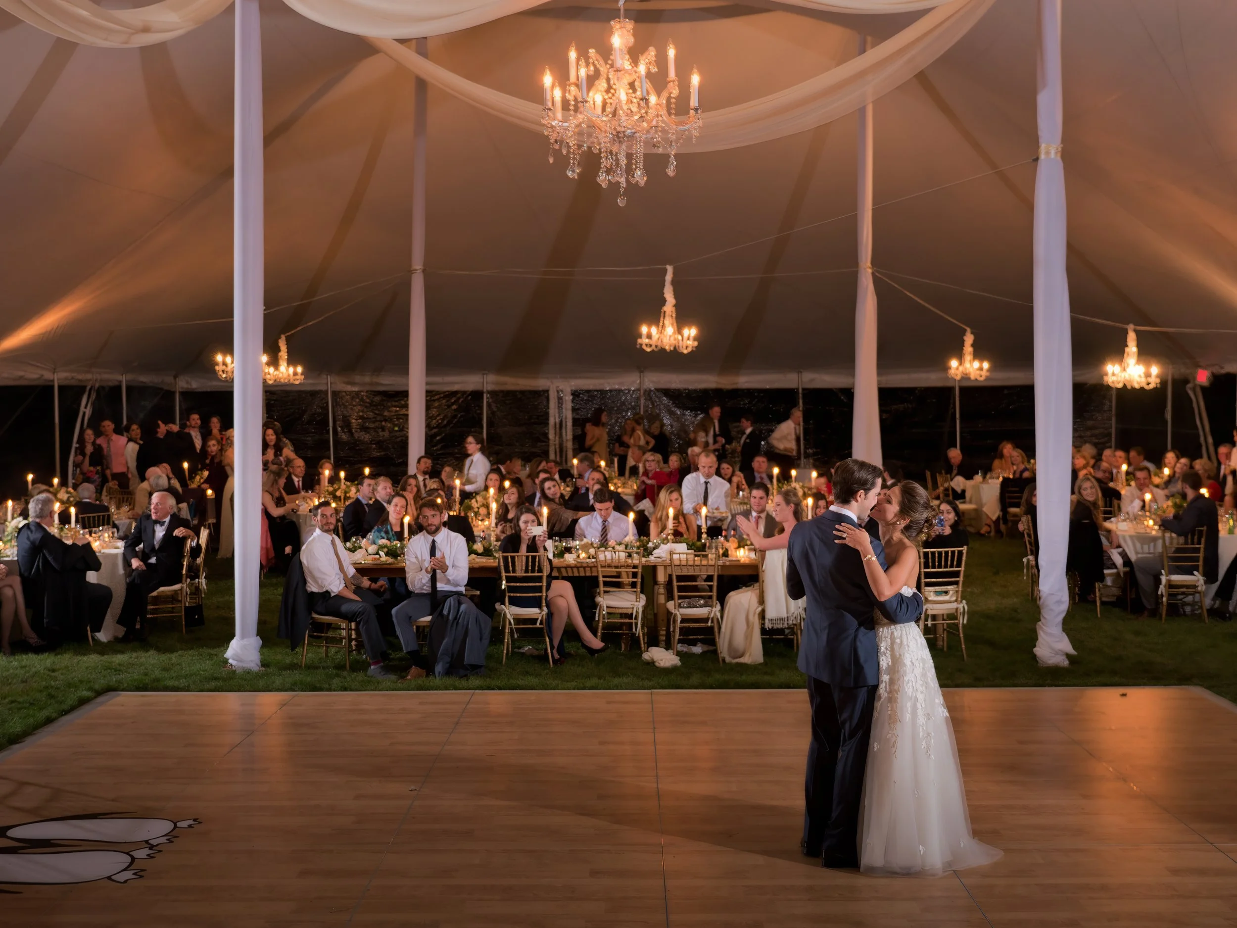 Bride and groom sharing a kiss during their first dance at a tented wedding reception in Litchfield County Connecticut.