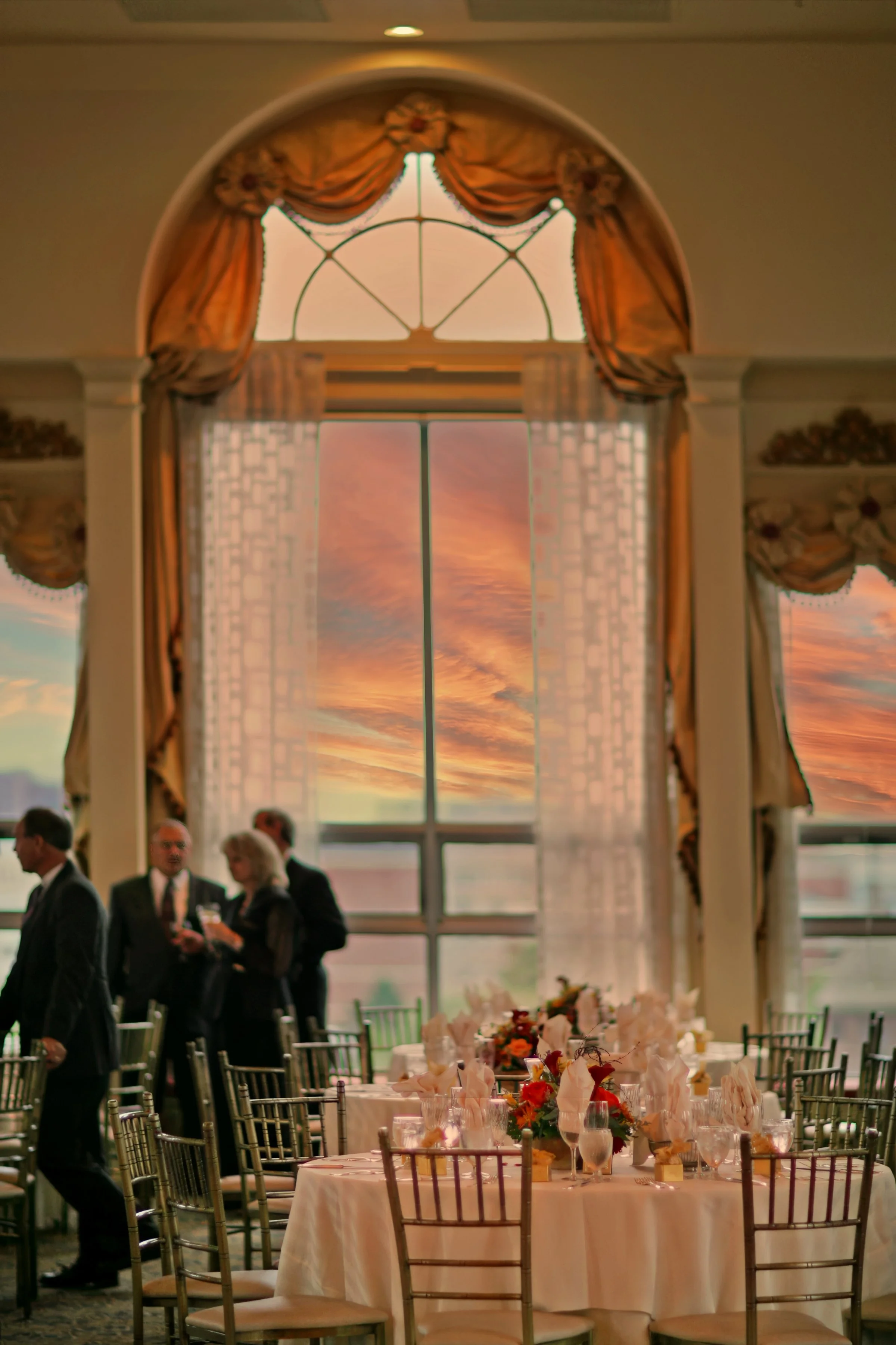 Tablescapes and floral decor inside Bond Ballroom as guests enjoy cocktail hour.