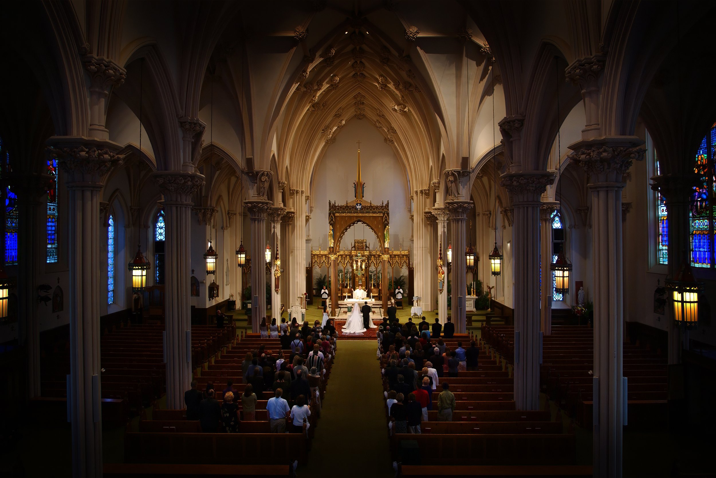 Balcony view of a wedding ceremony inside the Cathedral of Saint Patrick with guests gathered below.