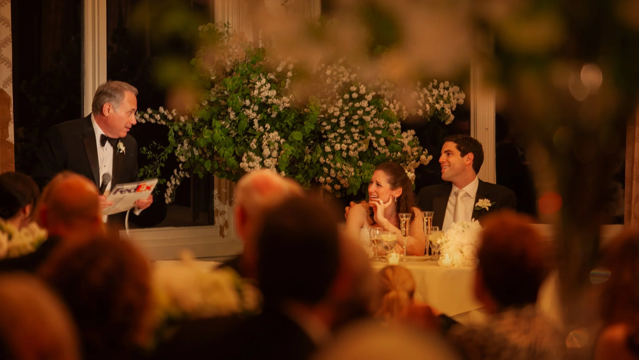 Wedding guests listen to a toast in Ocean Cliff ballroom.