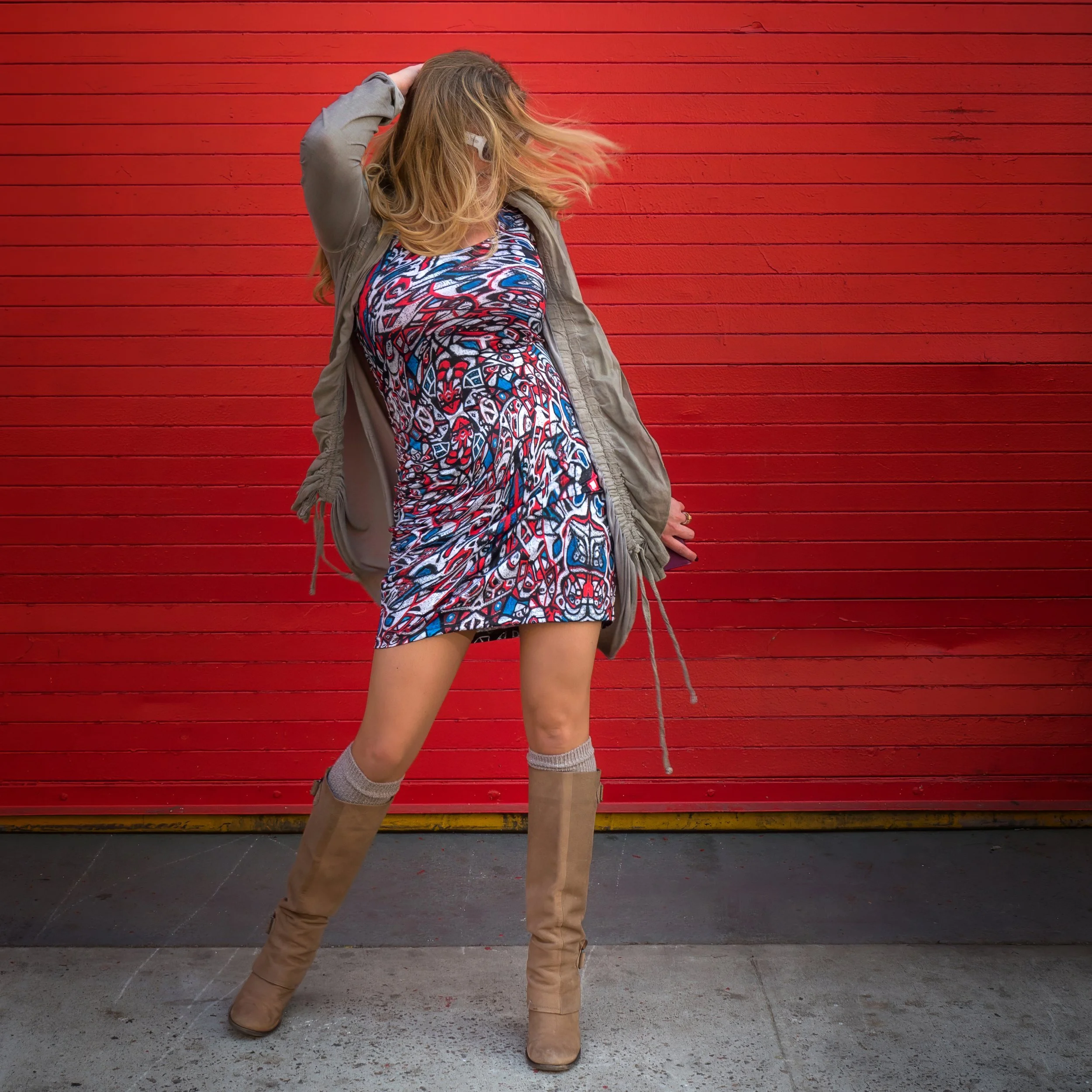 Confident young woman in the streets of New York City with hair across her face during fashion photography session