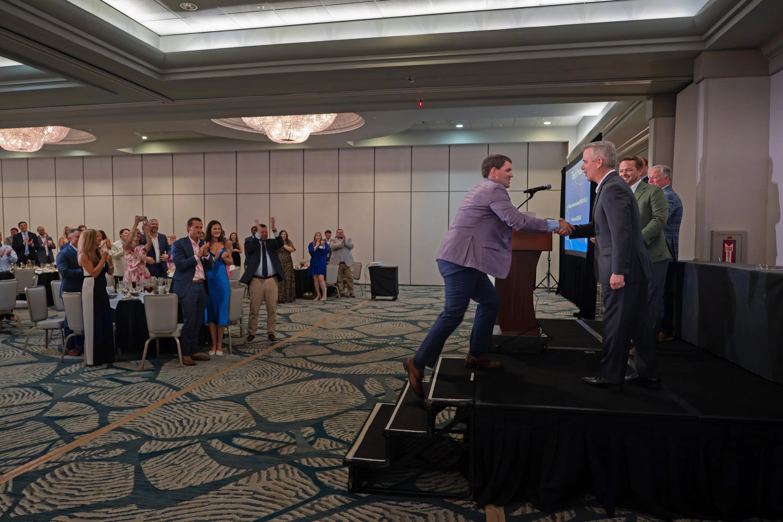 Guests giving a standing ovation as an award recipient takes the stage at Sonesta Resort Hilton Head.