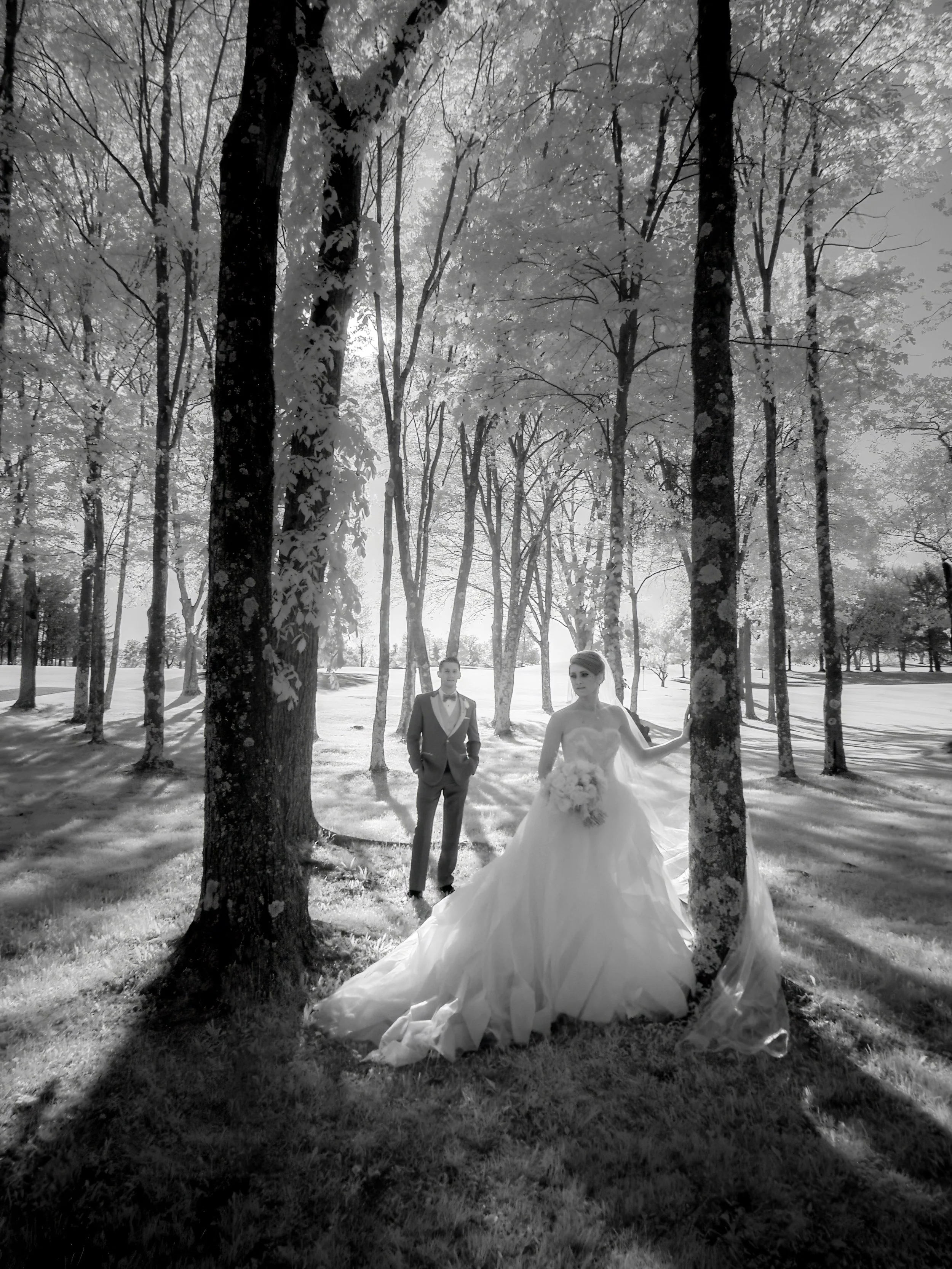 Ethereal black and white portrait of a bride and groom in a wooded area at Salem Golf Club.