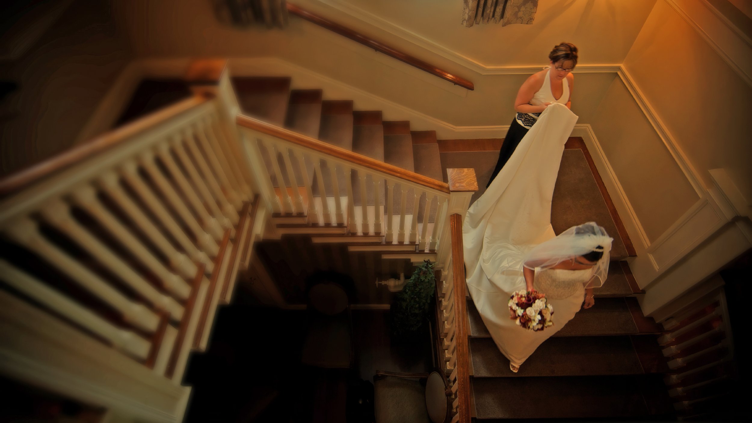 Bride descends the grand staircase at Ocean Cliff.