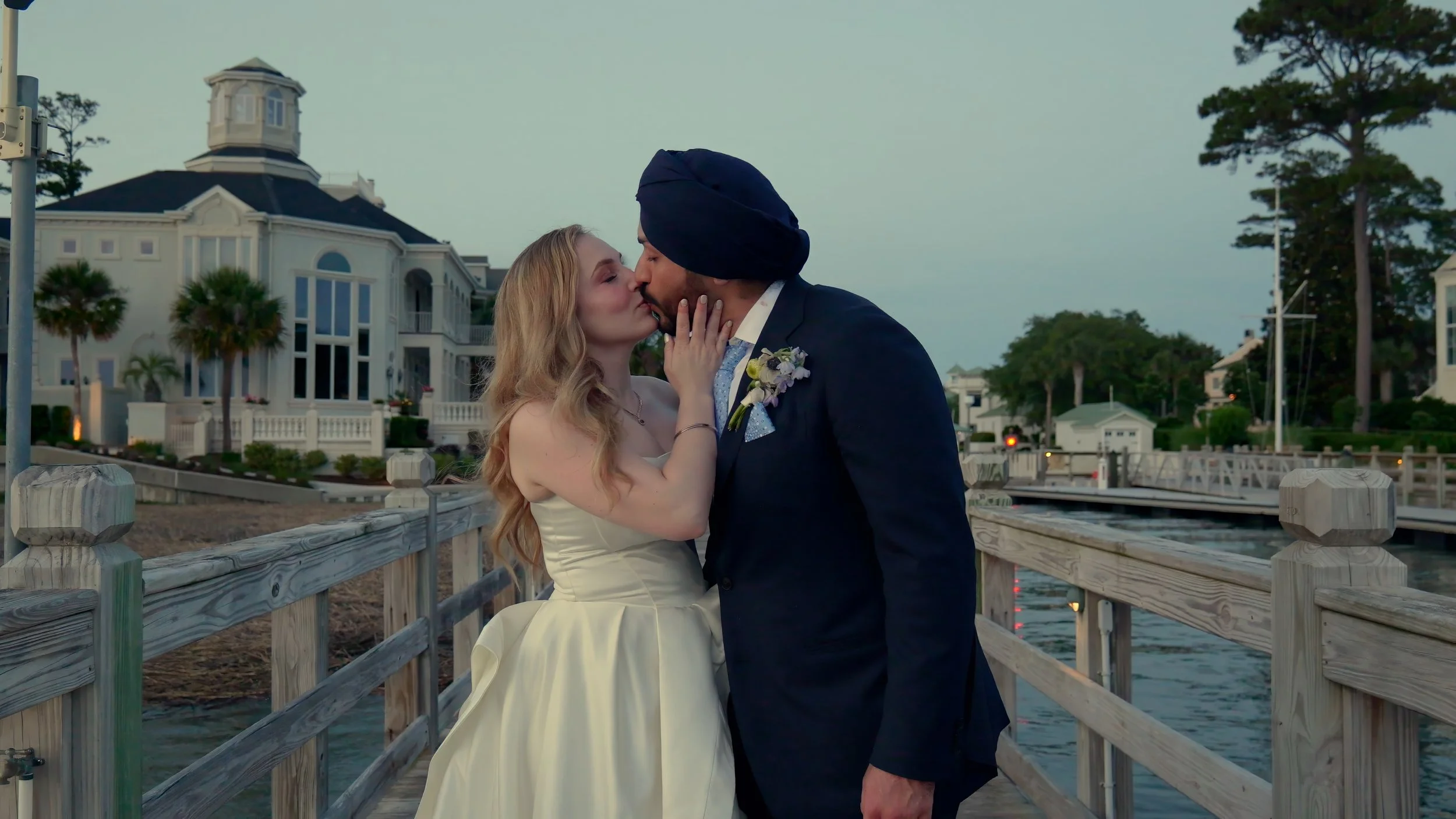 Bride and groom kissing by the waterfront during wedding portraits at South Carolina Yacht Club Hilton Head SC