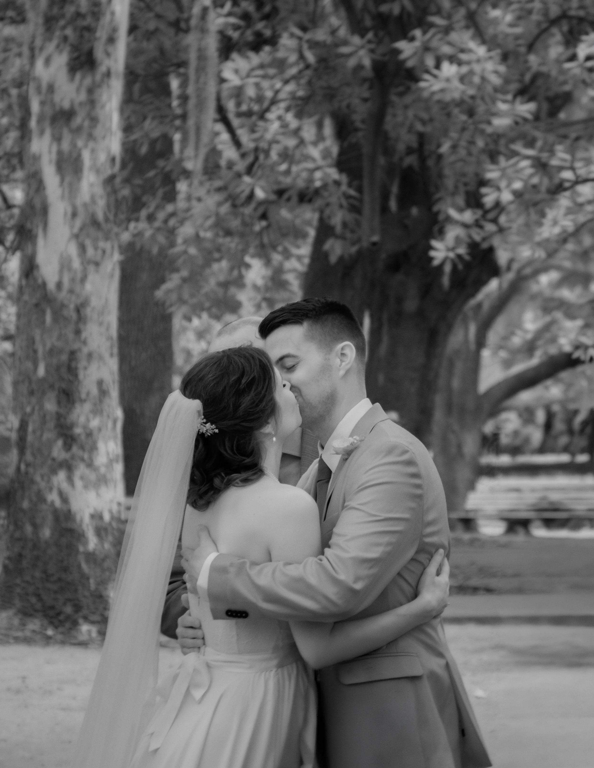 Tim and Daniella share their first kiss as a married couple beneath the live oaks during their Forsyth Park wedding ceremony.