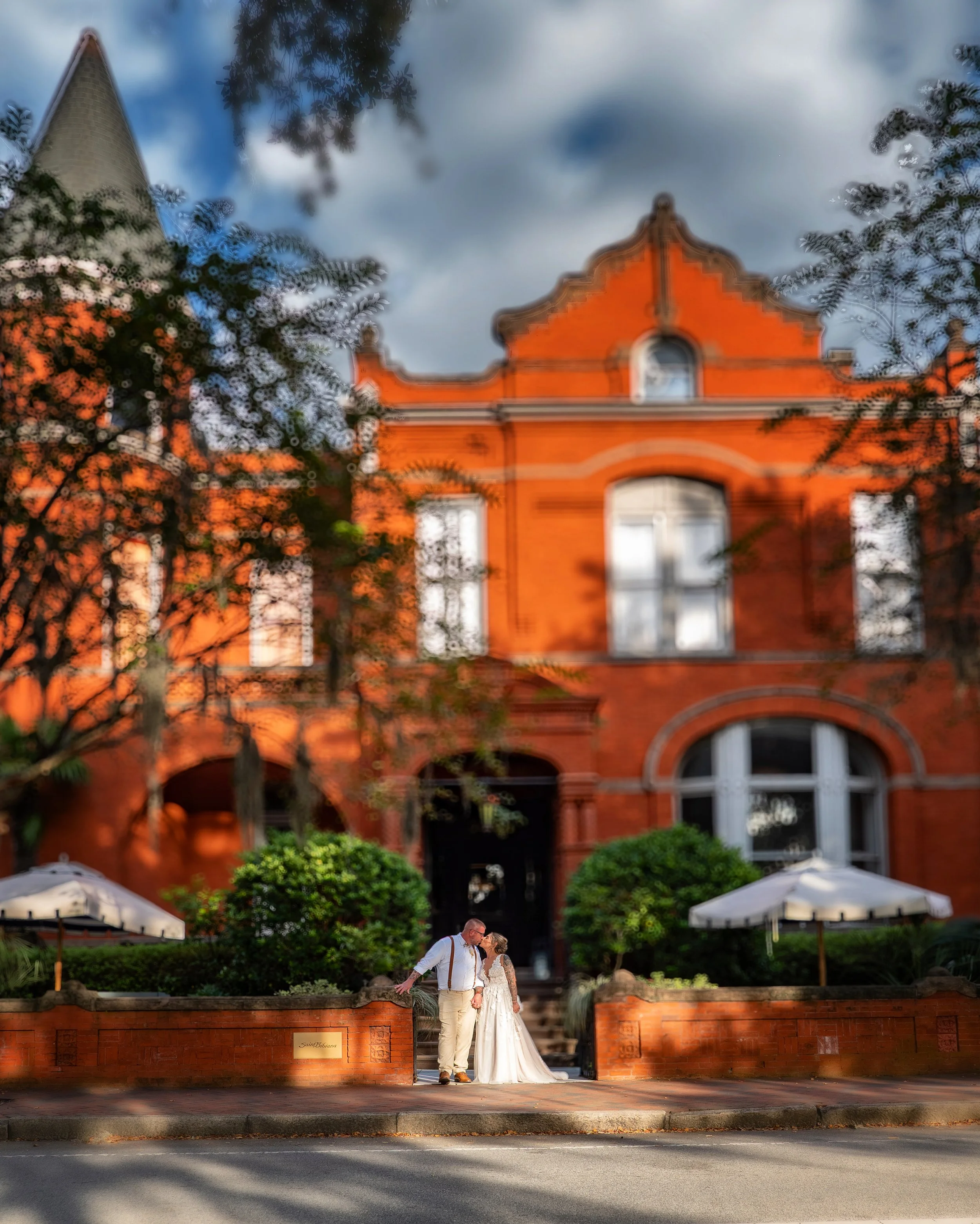 Bride and groom kissing at the entrance of Hotel Bardo during a Savannah luxury wedding.