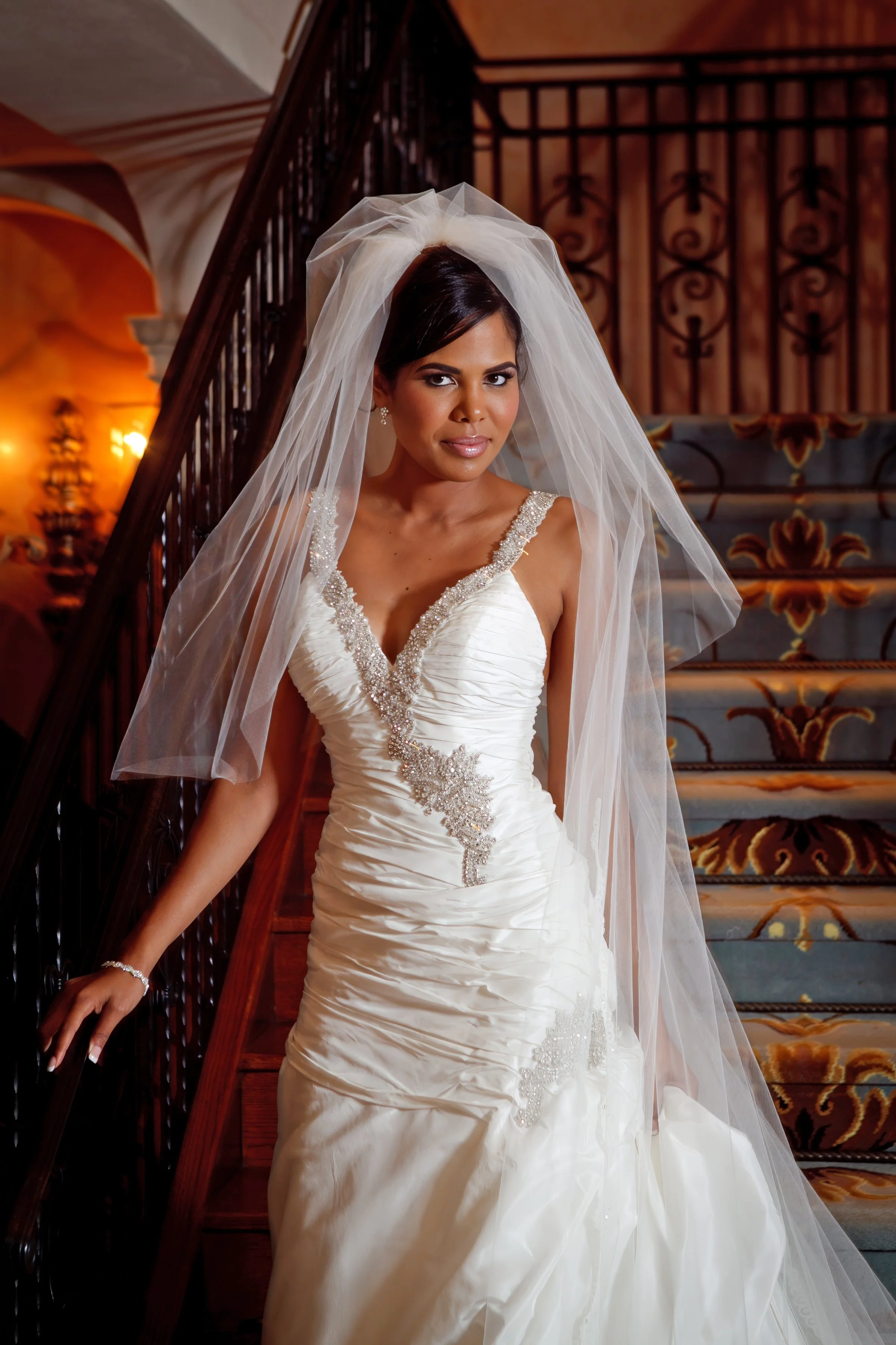Bridal portrait of the bride standing gracefully on the staircase at Delamar Greenwich Harbor.