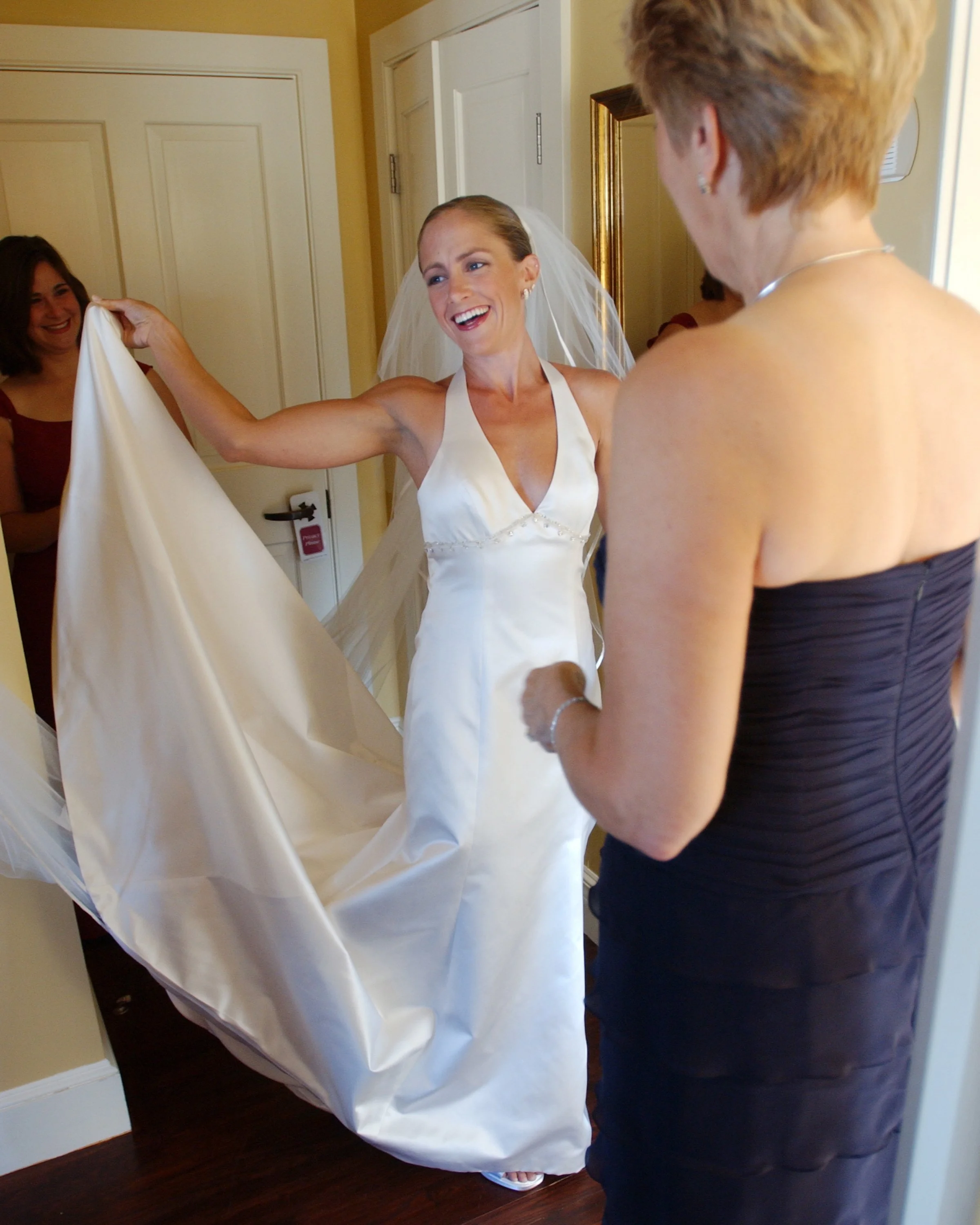 Bride laughing with her mother and bridesmaids at Castle Hill before the ceremony.