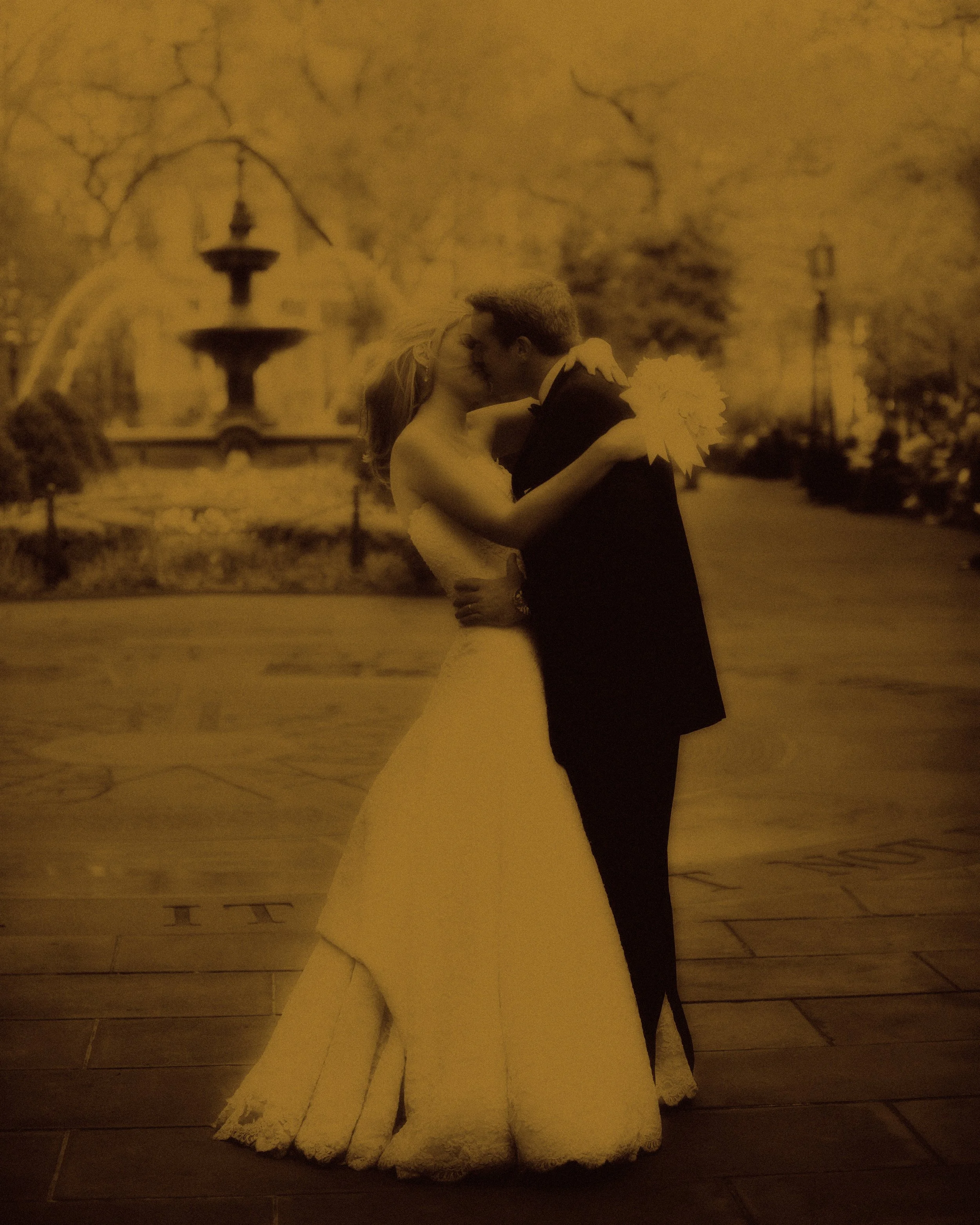 Bride and groom kissing in City Hall Park with ethereal split tone lighting in New York City