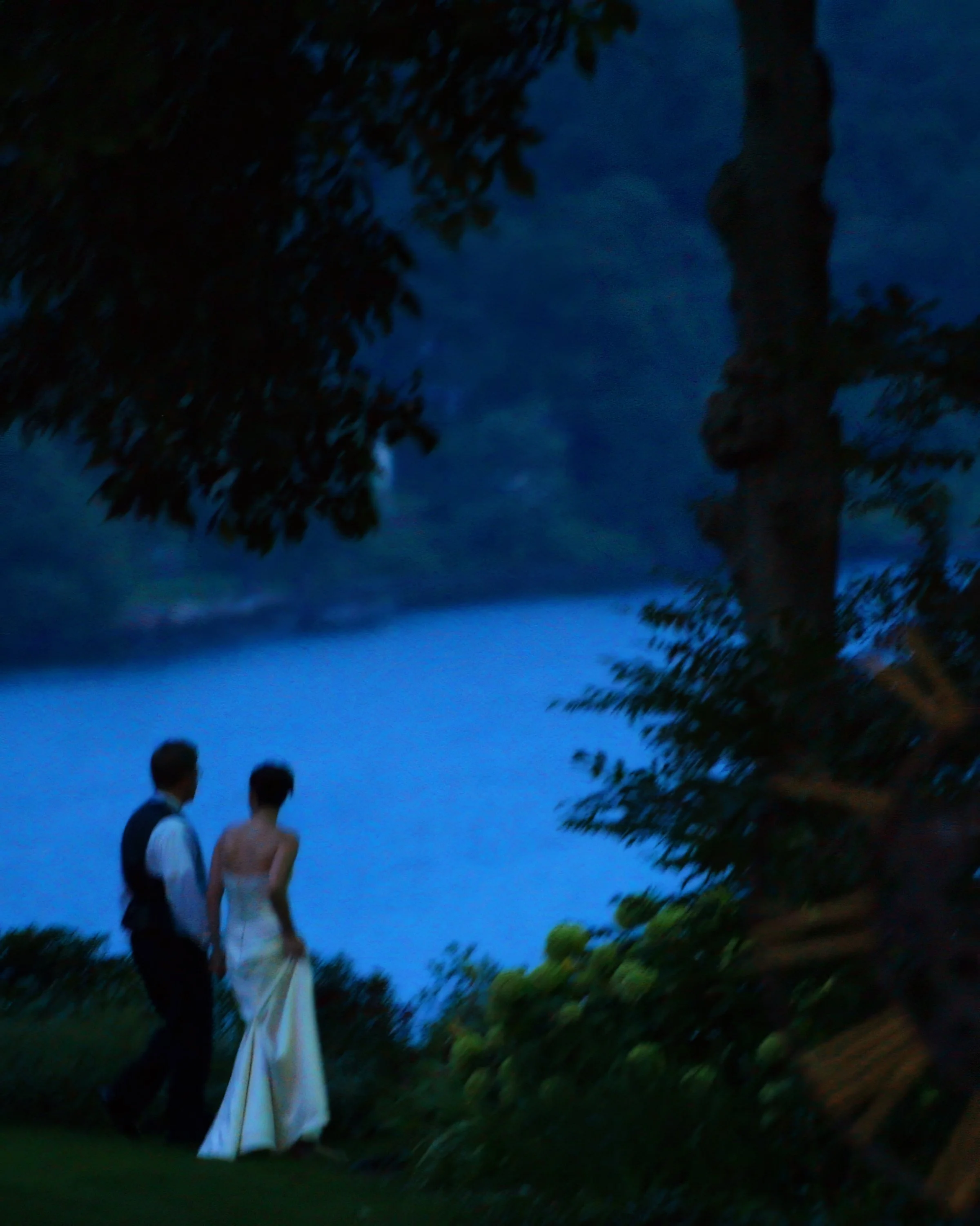 Bride and groom share a romantic twilight stroll overlooking the Connecticut River at Saint Clements Castle.