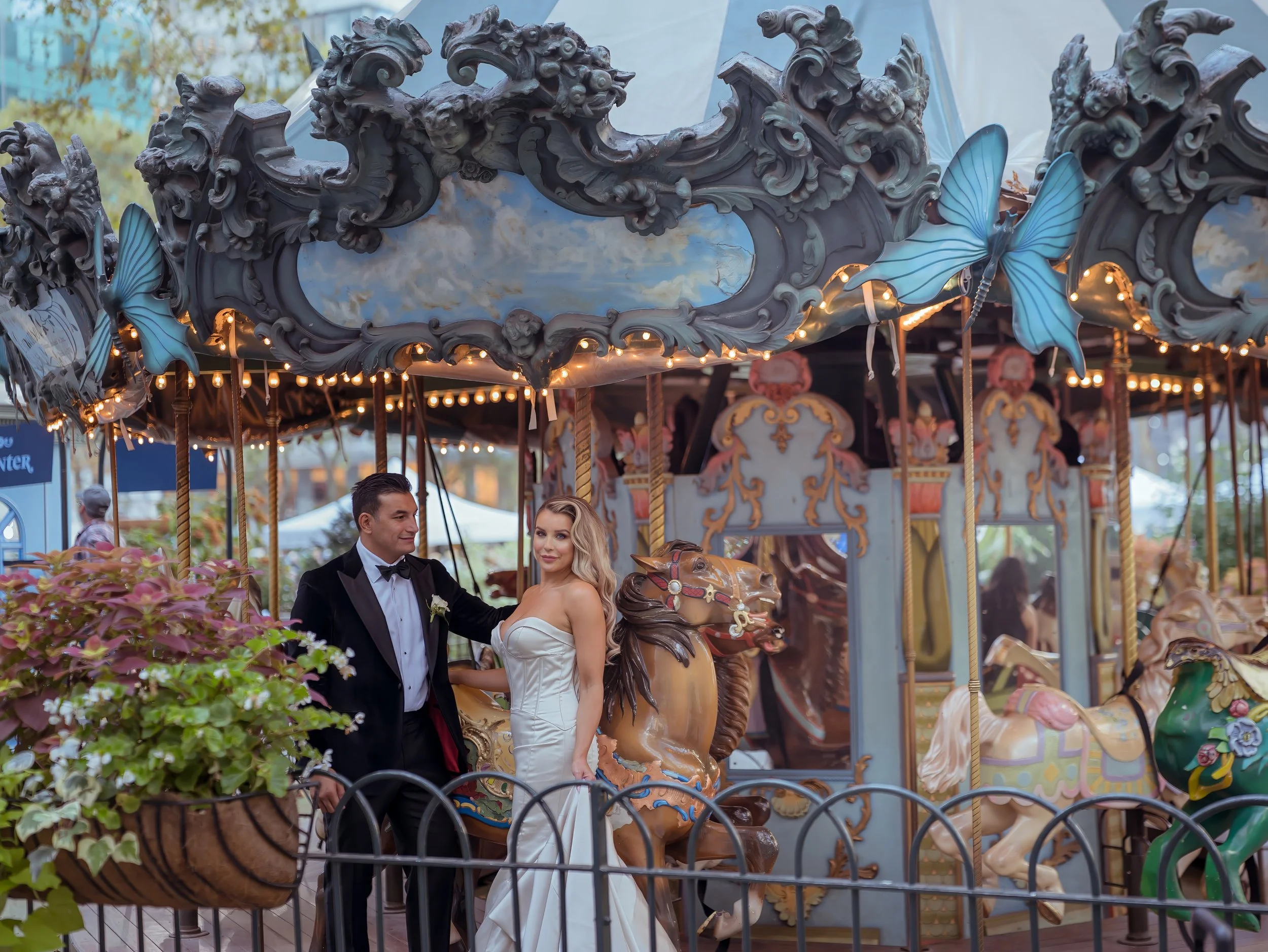 Bride and groom romantic moment on Bryant Park carousel during Midtown Manhattan wedding photography