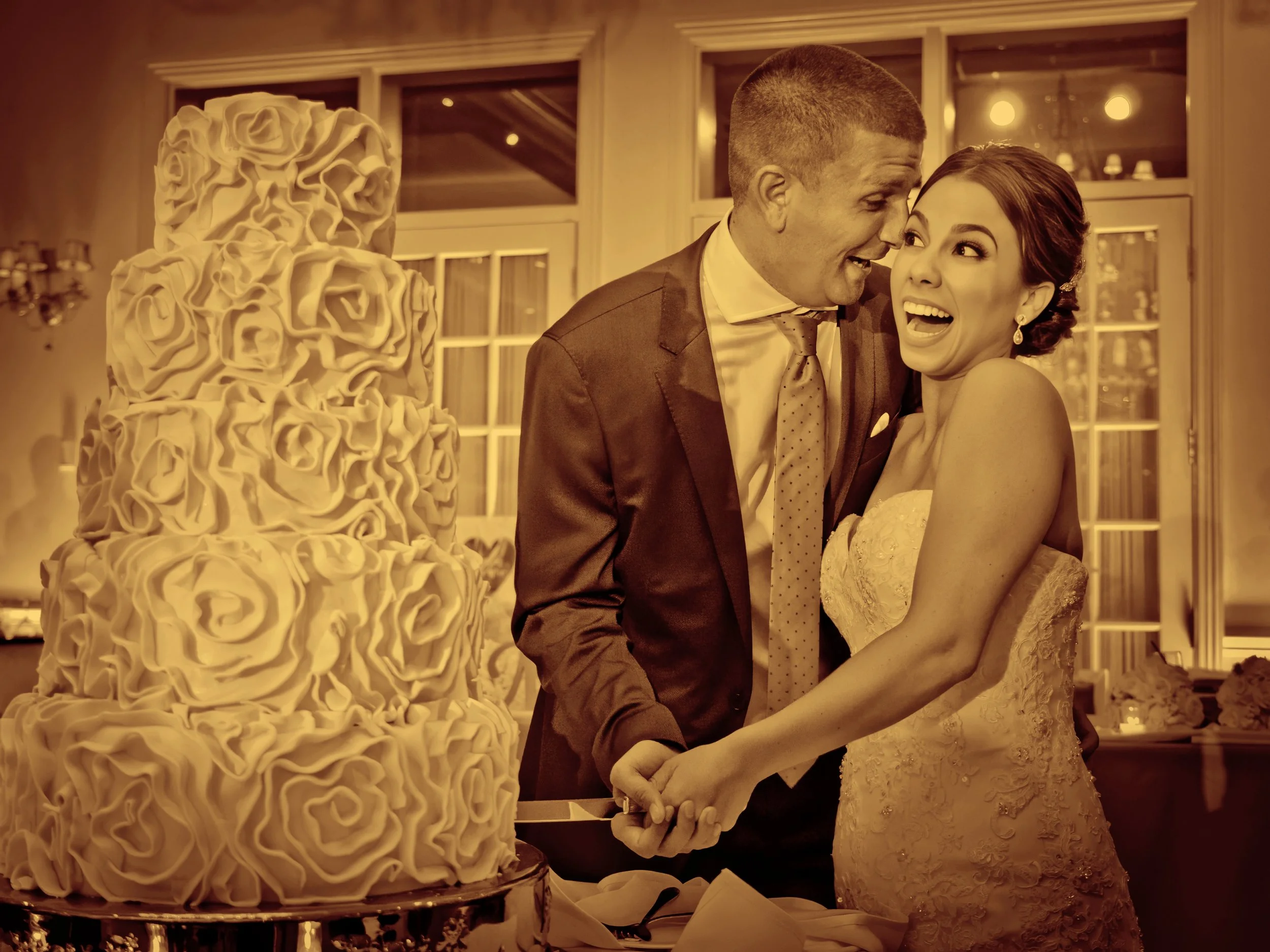 The bride and groom joyfully cutting their wedding cake at The Grandview.