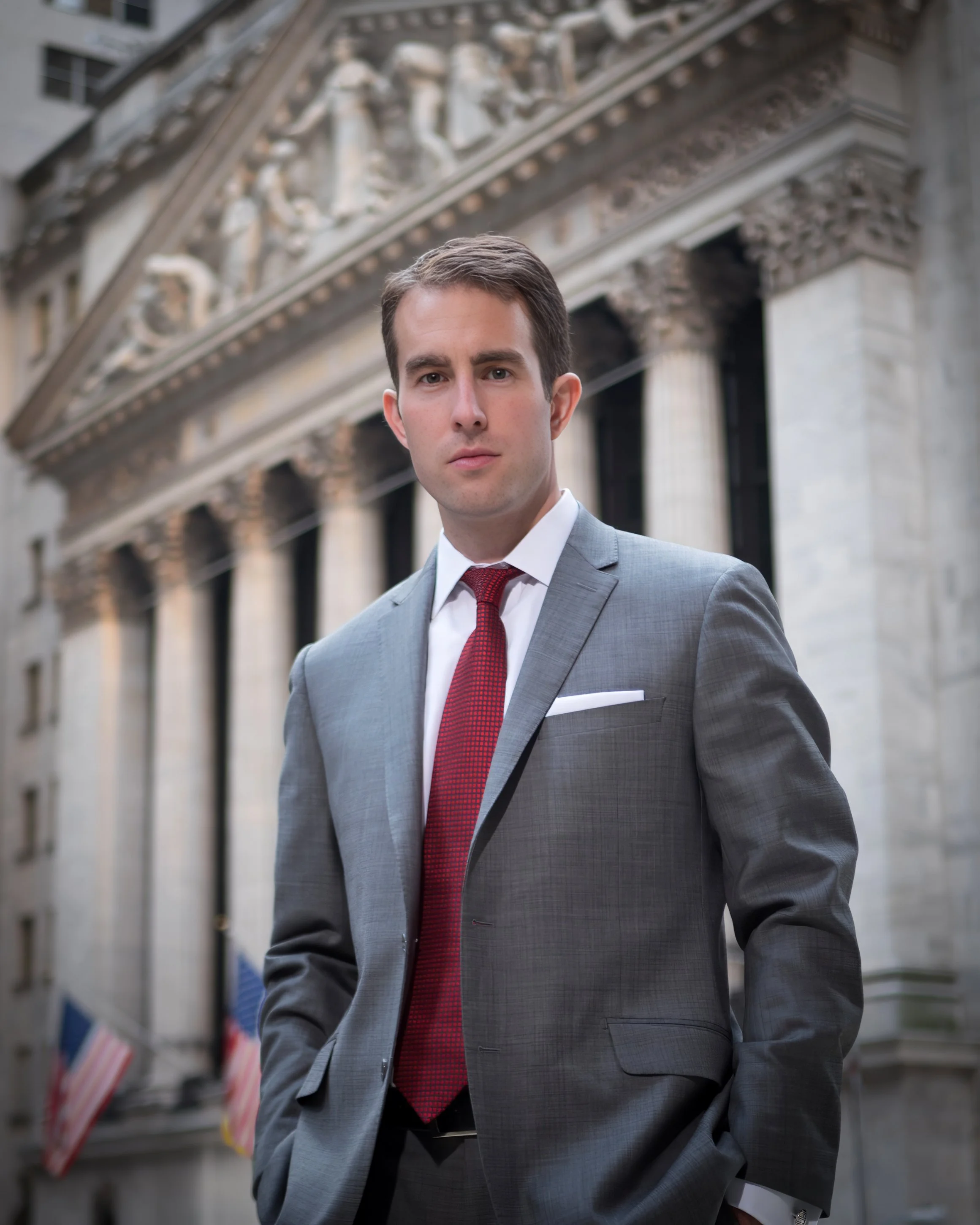 Portrait of a Wall Street executive with the New York Stock Exchange in the background in Manhattan