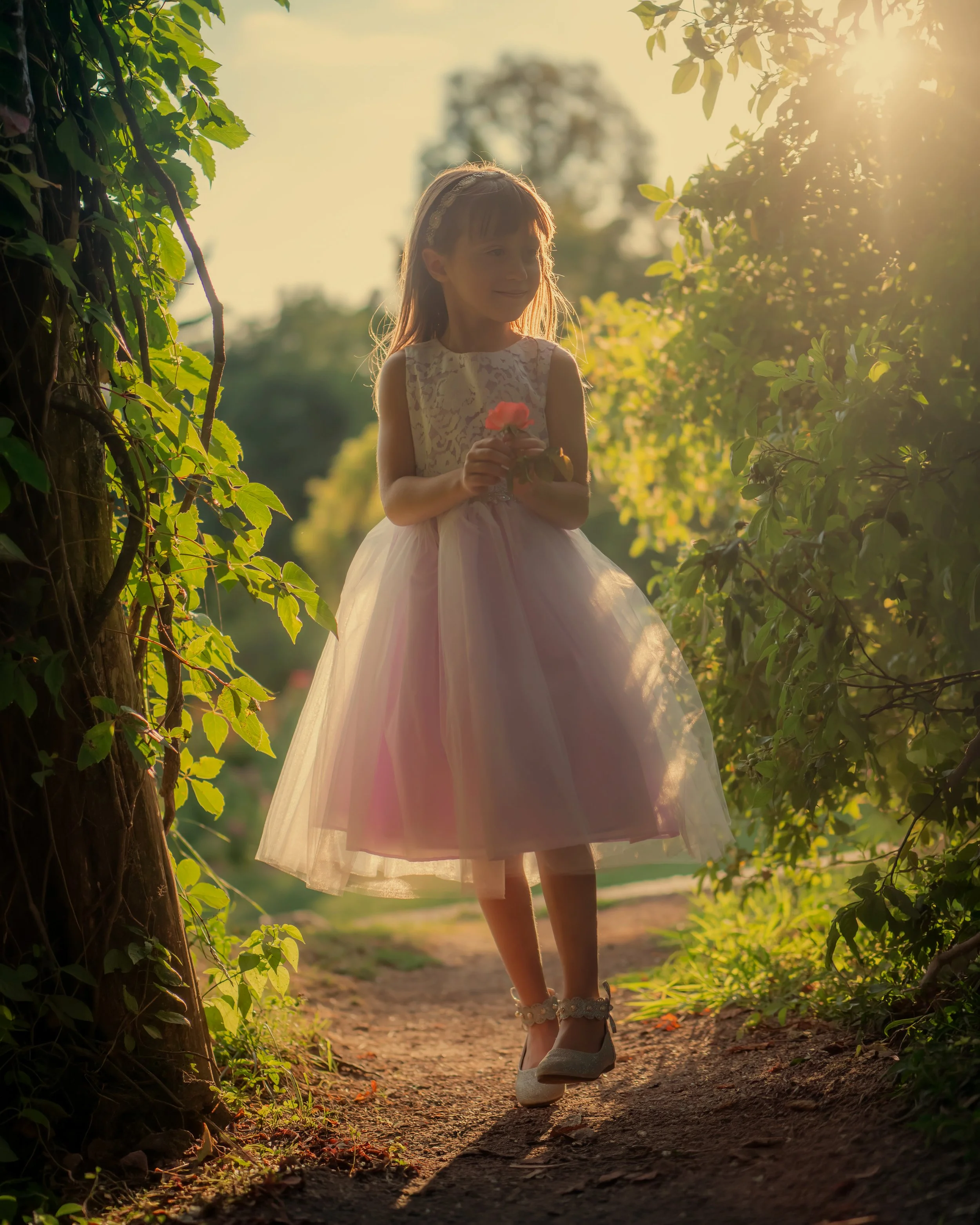 Child portrait framed by archways in Elizabeth Park rose garden Hartford Connecticut