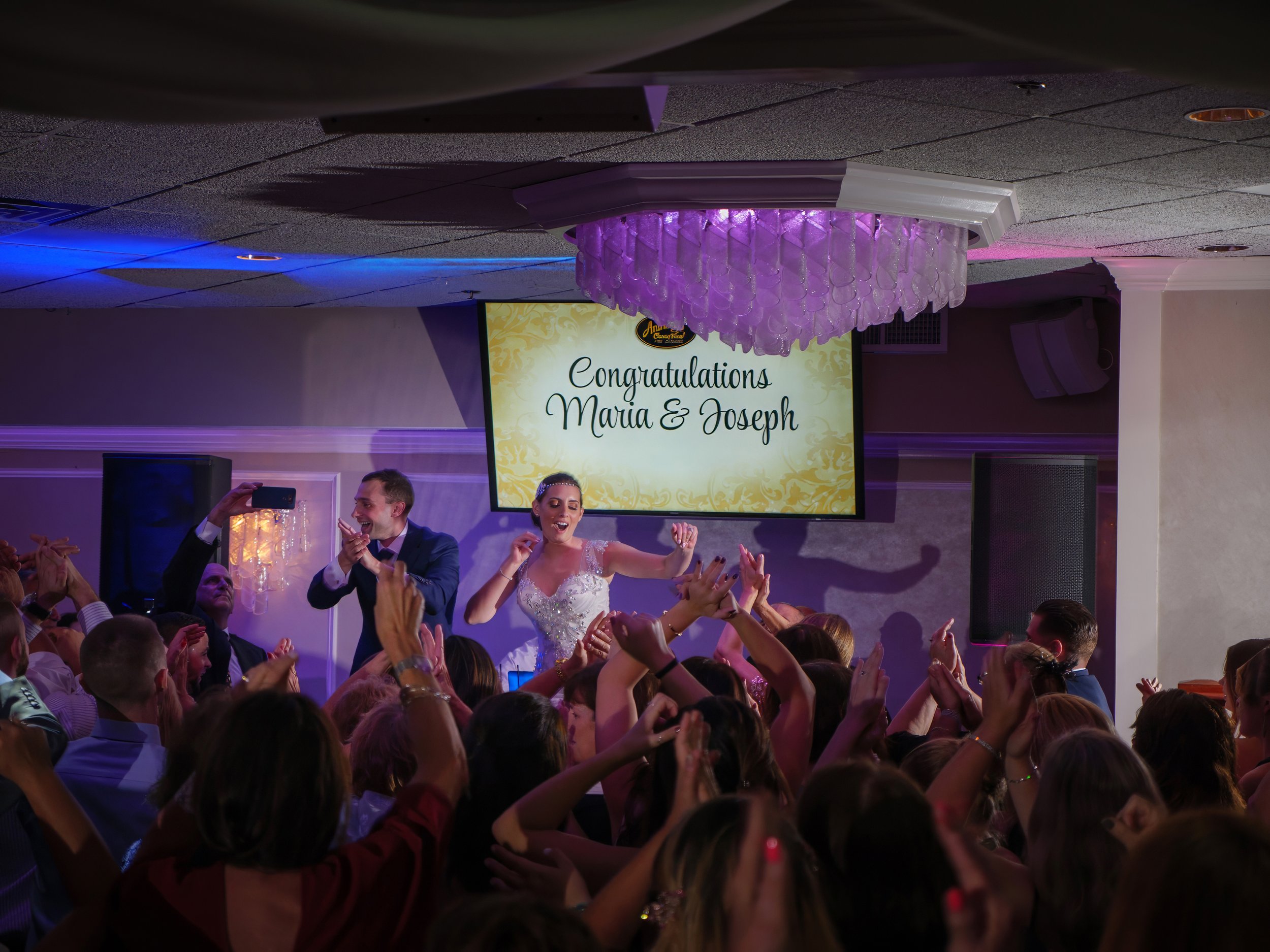 Bride and groom dancing with guests during wedding reception at Anthony’s Ocean View New Haven Connecticut