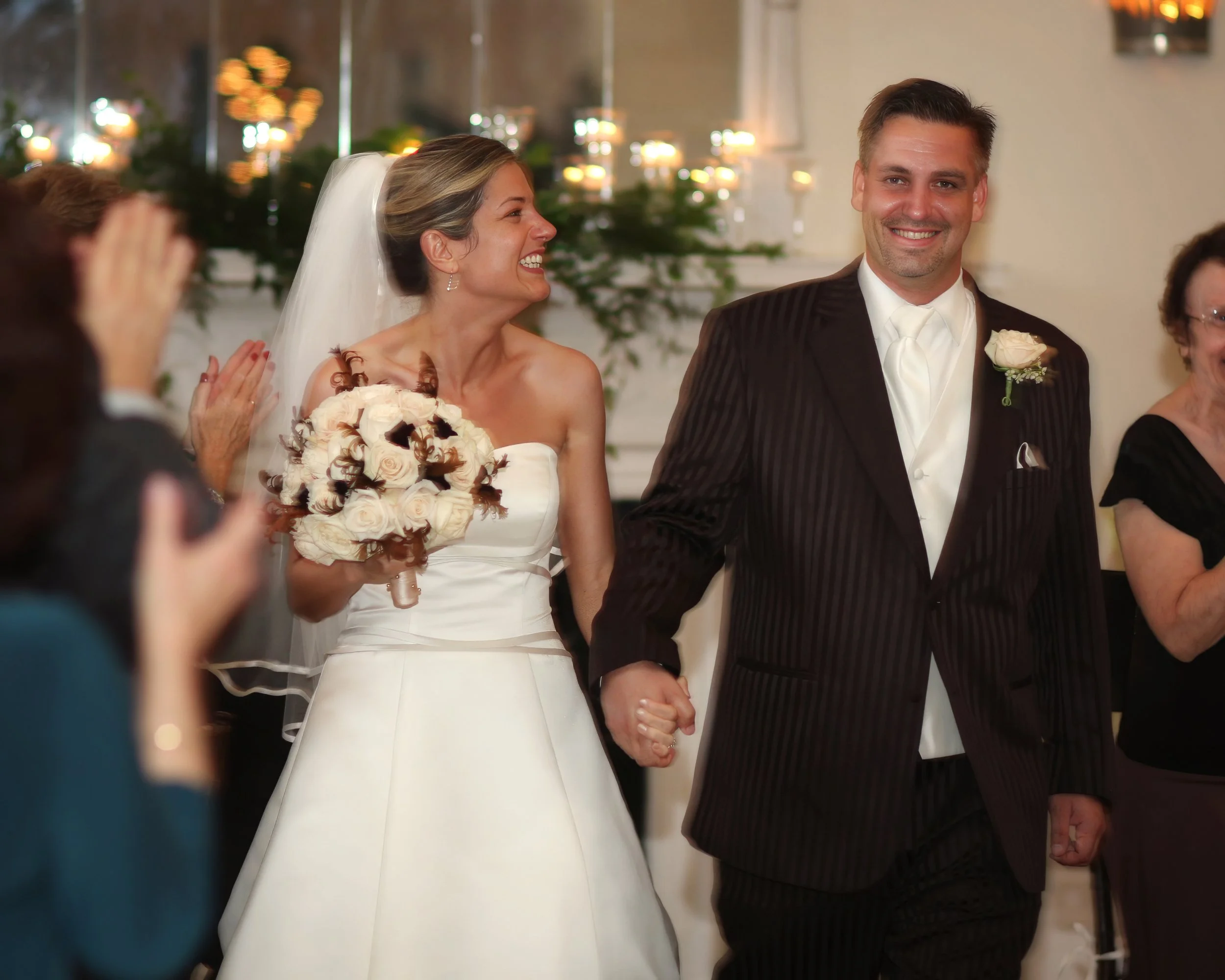 Bride and groom make a joyful grand entrance into the ballroom at the New Haven Lawn Club.