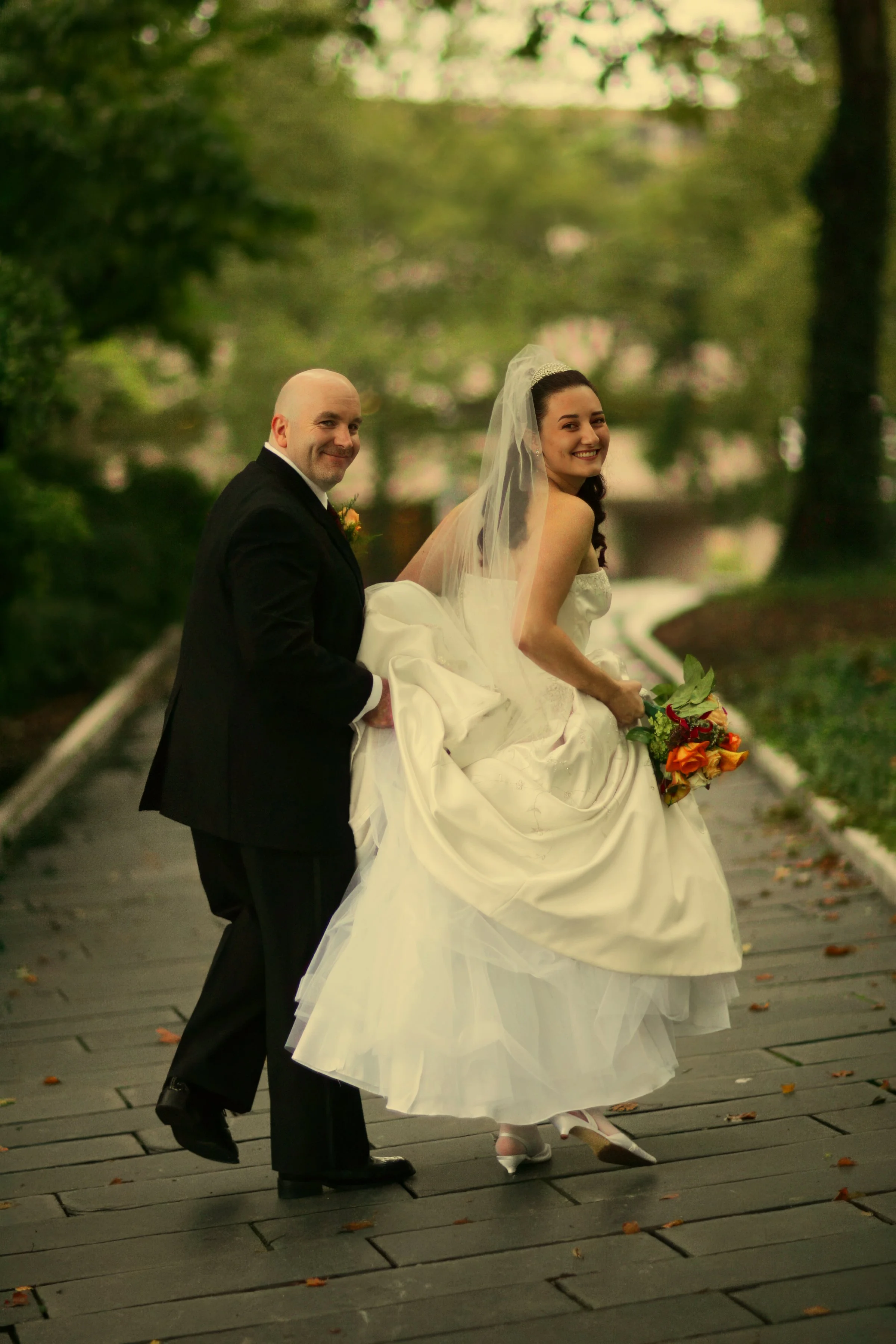 Bride and groom walk stylishly through Burr Mall during a Hartford wedding.