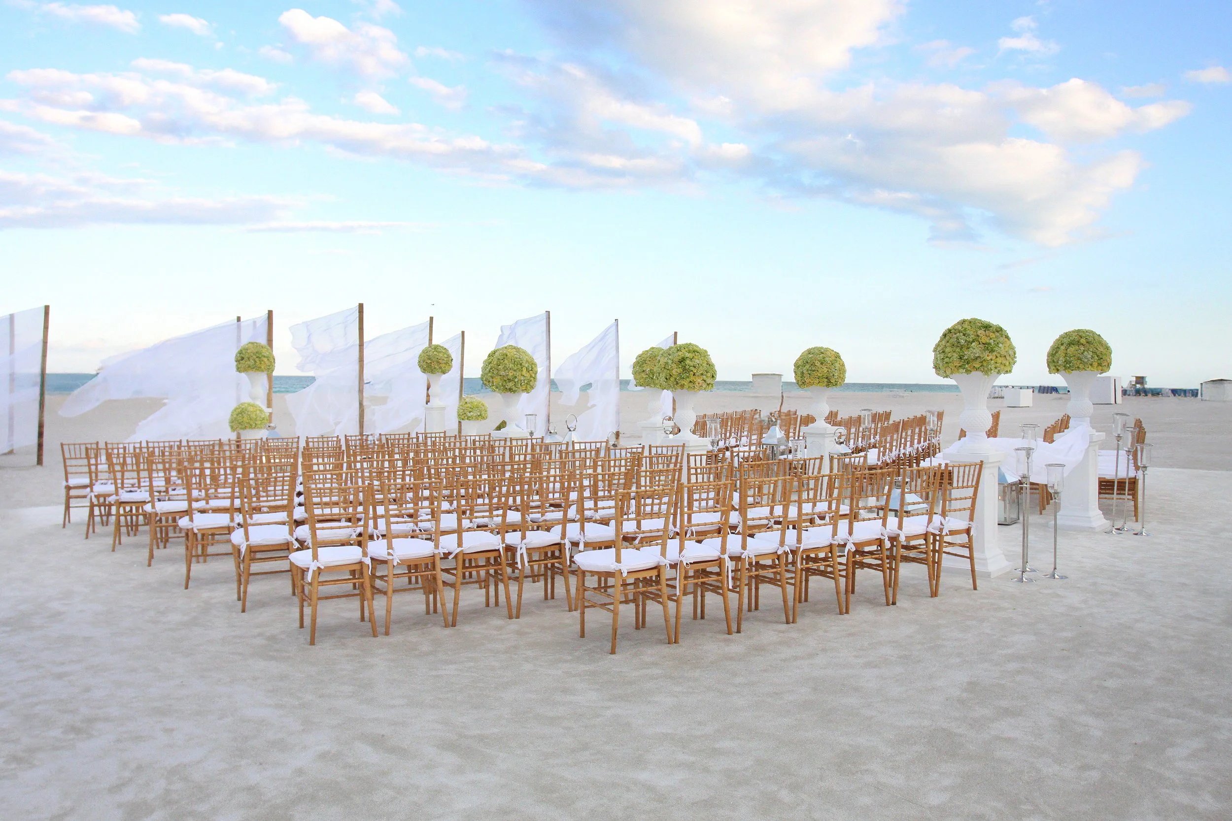 Luxury beach wedding ceremony setup in Hilton Head with elegant decor.