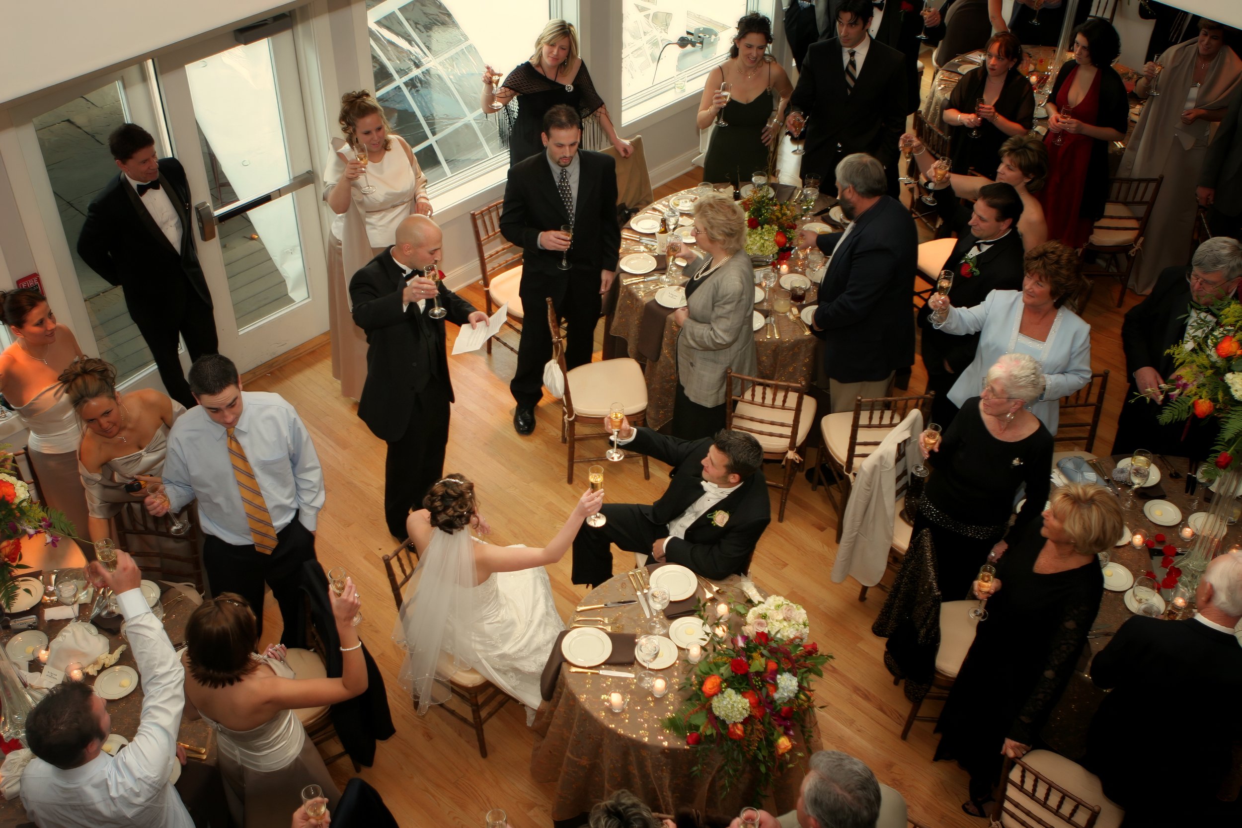 Best man delivers a toast as wedding guests raise their glasses inside the Guilford Yacht Club clubhouse.
