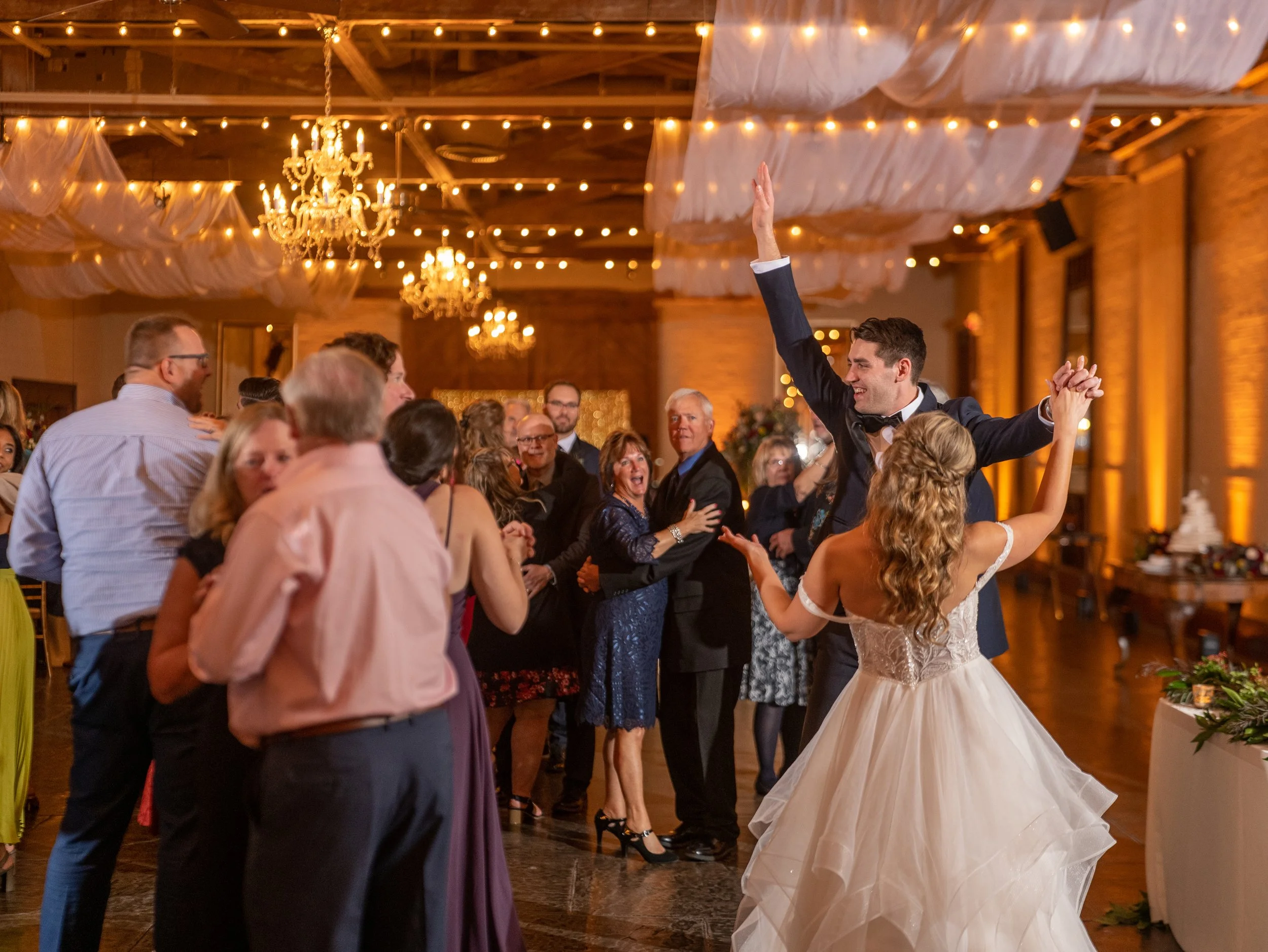 Bride and groom dancing with guests during their Savannah Station wedding reception in Savannah, Georgia.
