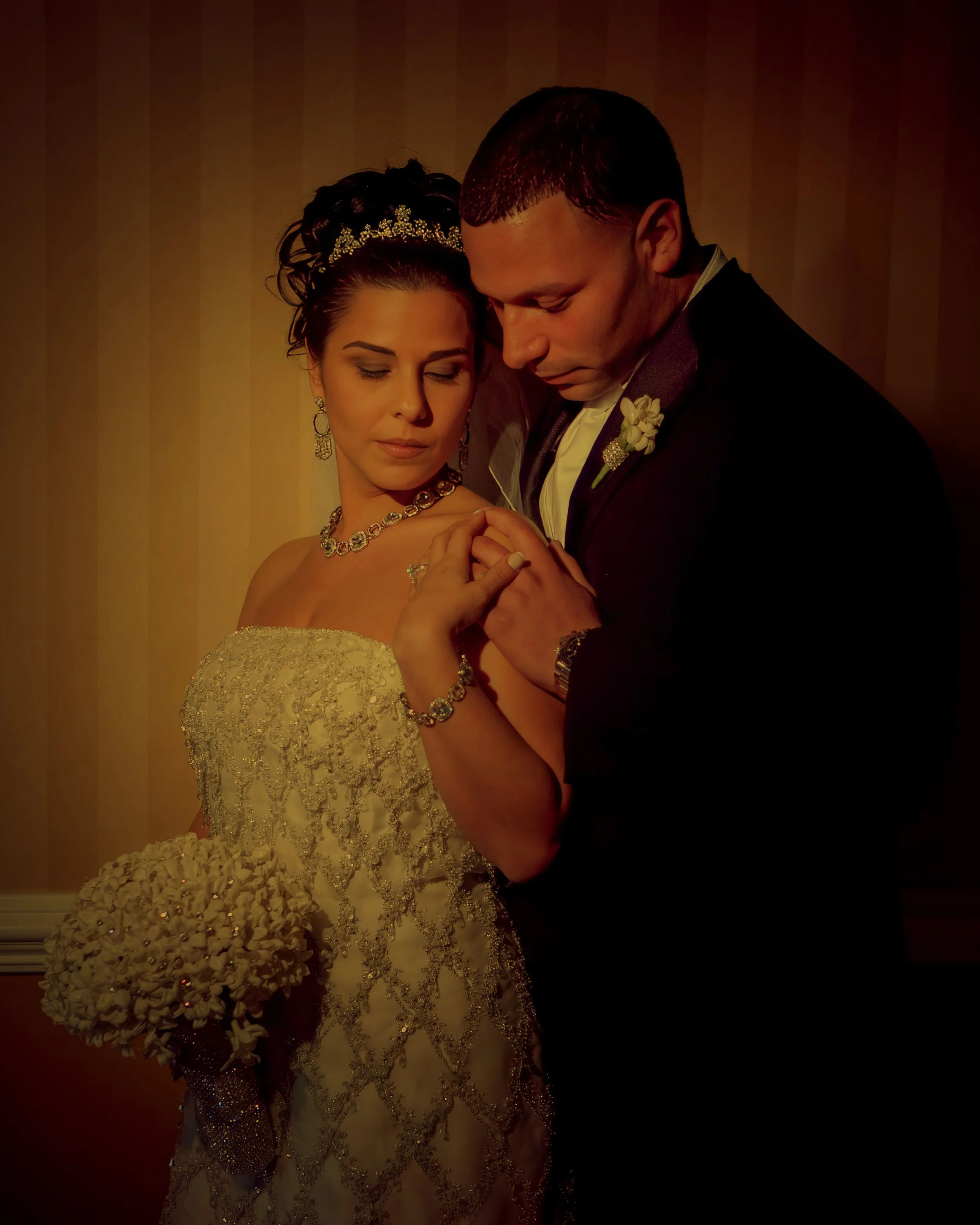 Cinematic close-up portrait of bride and groom sharing an intimate moment.