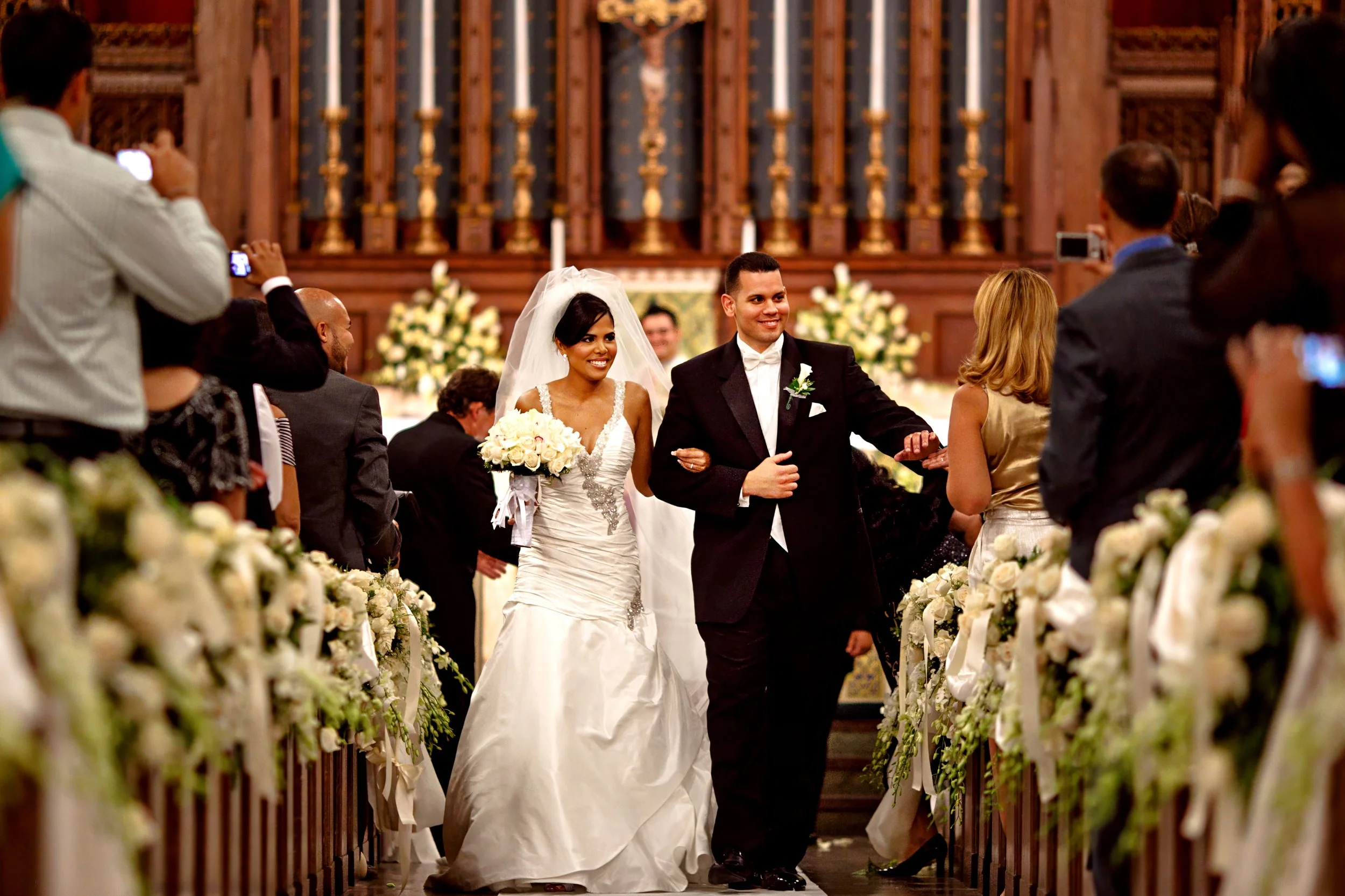 A bride and groom celebrate in their recessional at a church wedding at Saint Mary's in Stamford, CT