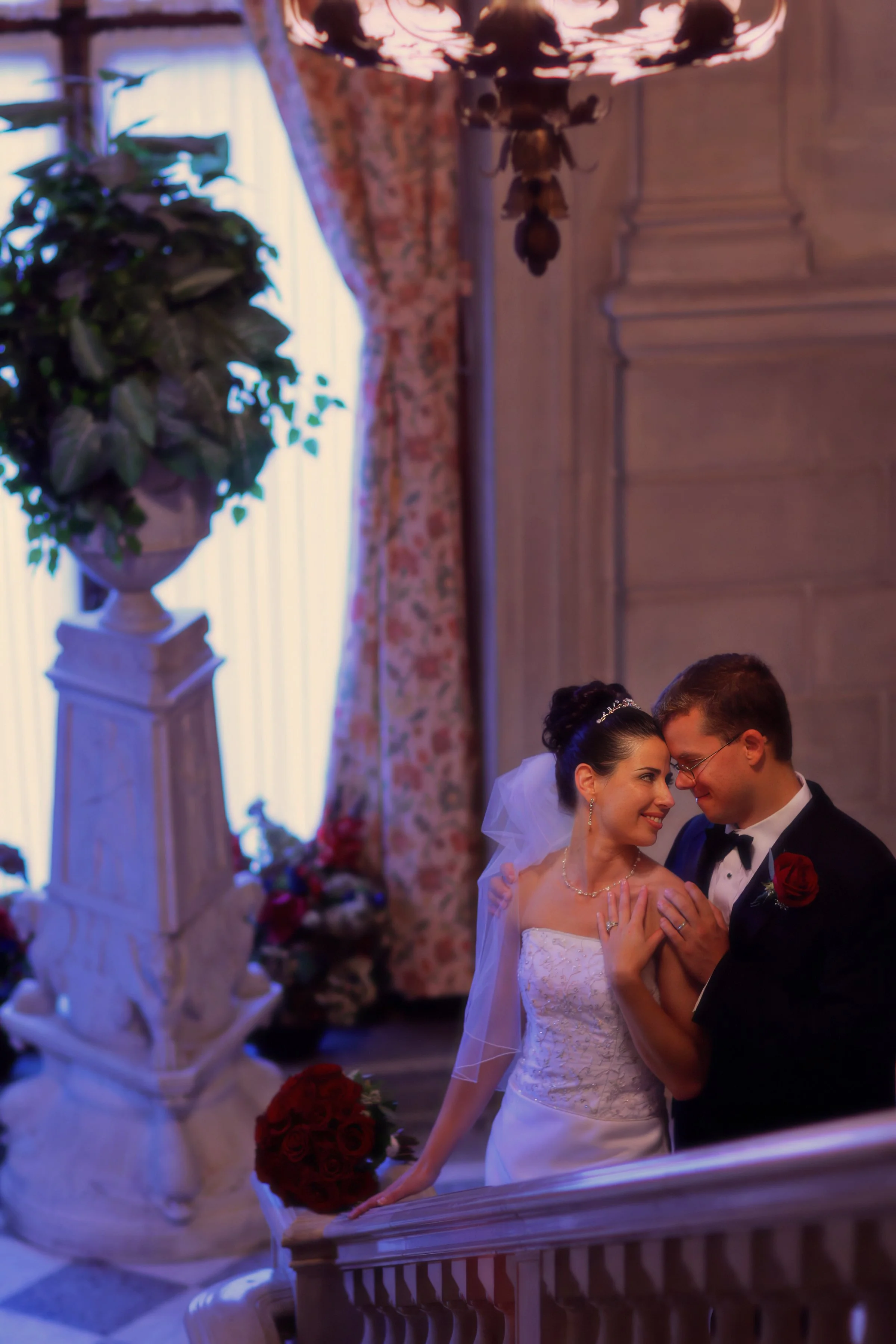 Romantic portrait of bride and groom on the grand staircase inside Aldrich Mansion.