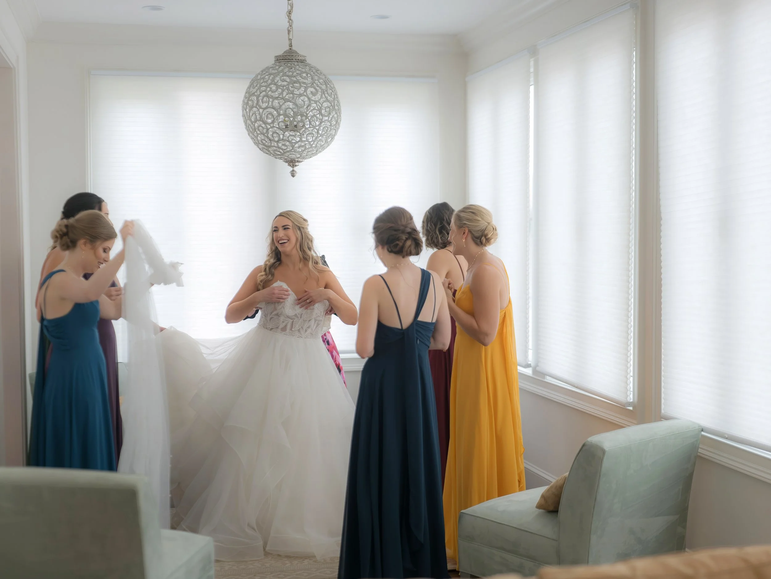 Bridesmaids assist the bride getting ready at The Jules in Downtown Savannah prior to a wedding at Savannah Station