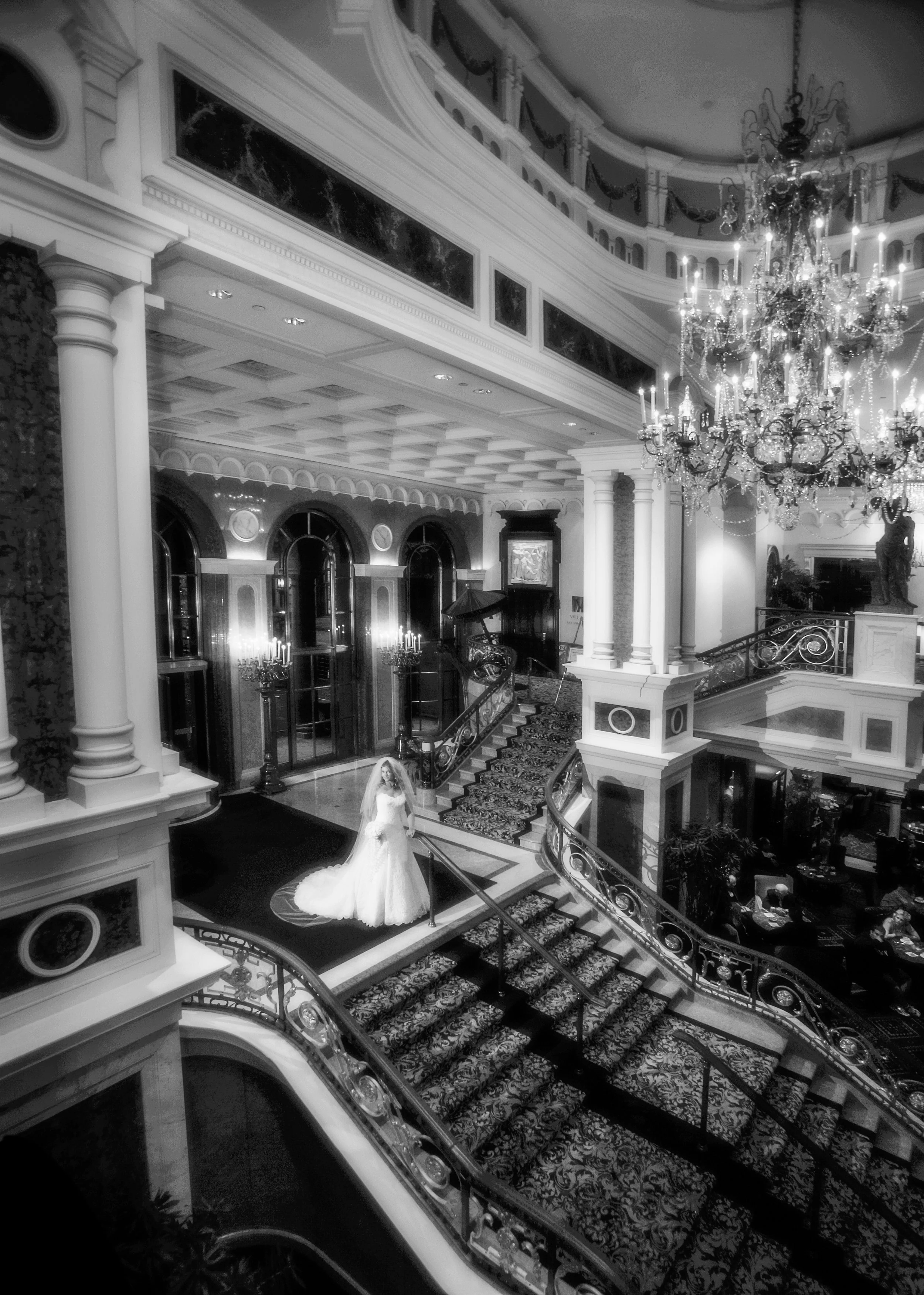 Bride standing on the grand foyer staircase at Lotte New York Palace Hotel