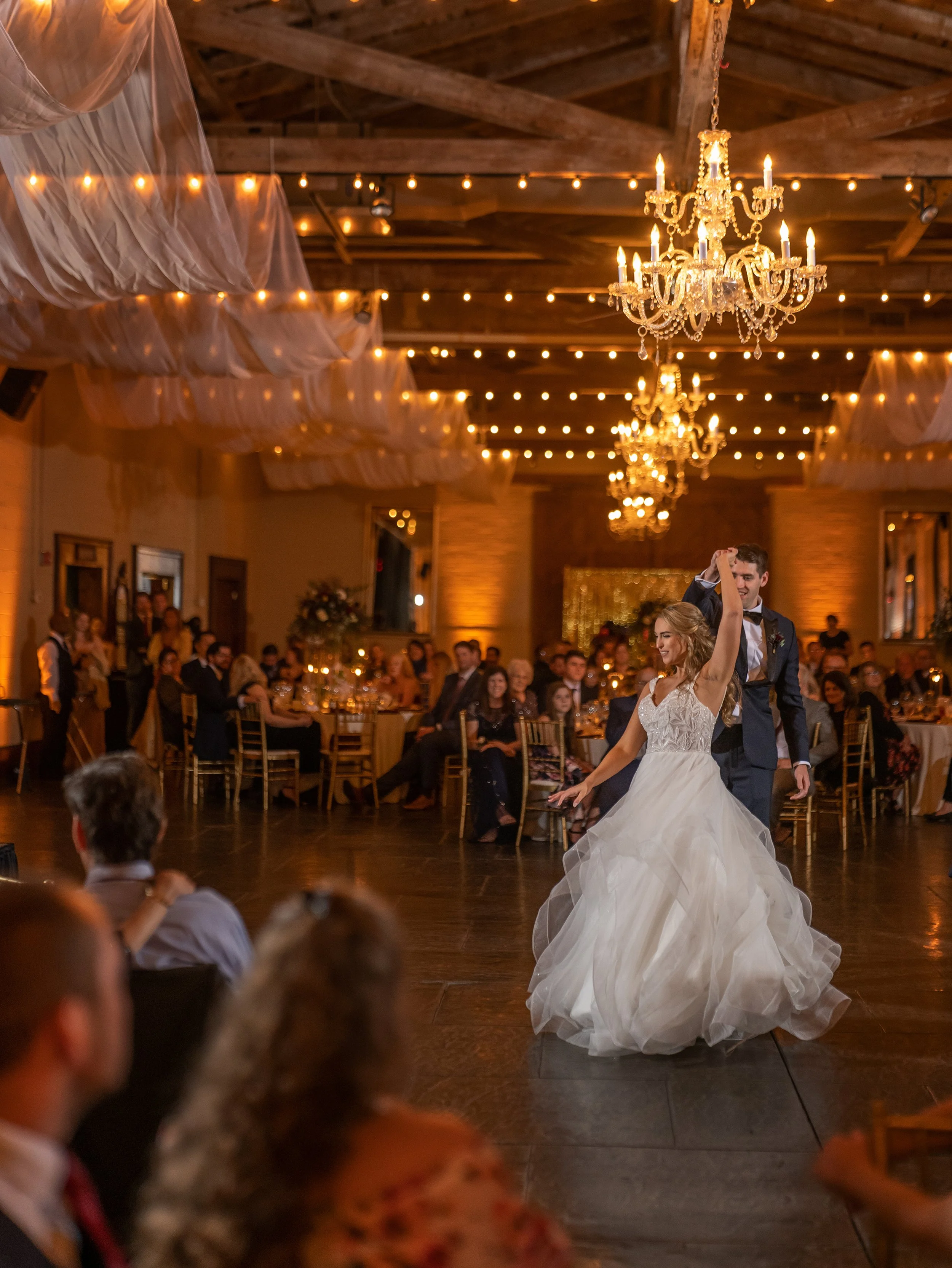 Bride and groom share a playful first dance in the Savannah Station ballroom during their wedding reception in Savannah, Georgia.