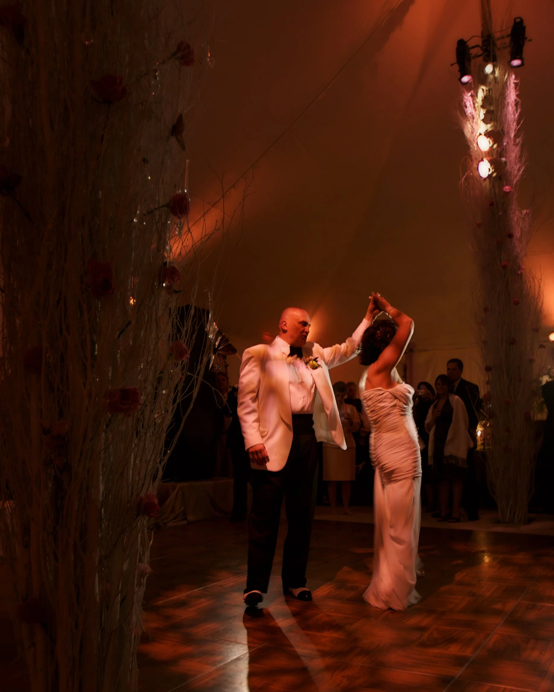 Groom spinning the bride on the dance floor during an estate wedding celebration in New London County Connecticut.