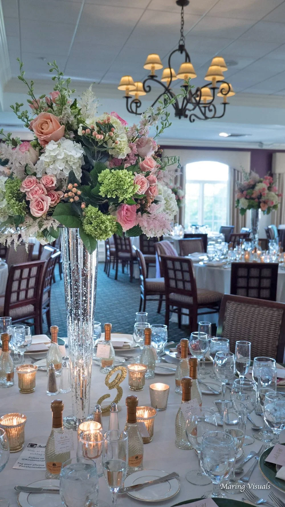 Tall floral centerpieces with colorful blooms in the clubhouse ballroom at a Salem Golf Club wedding in Westchester, NY.