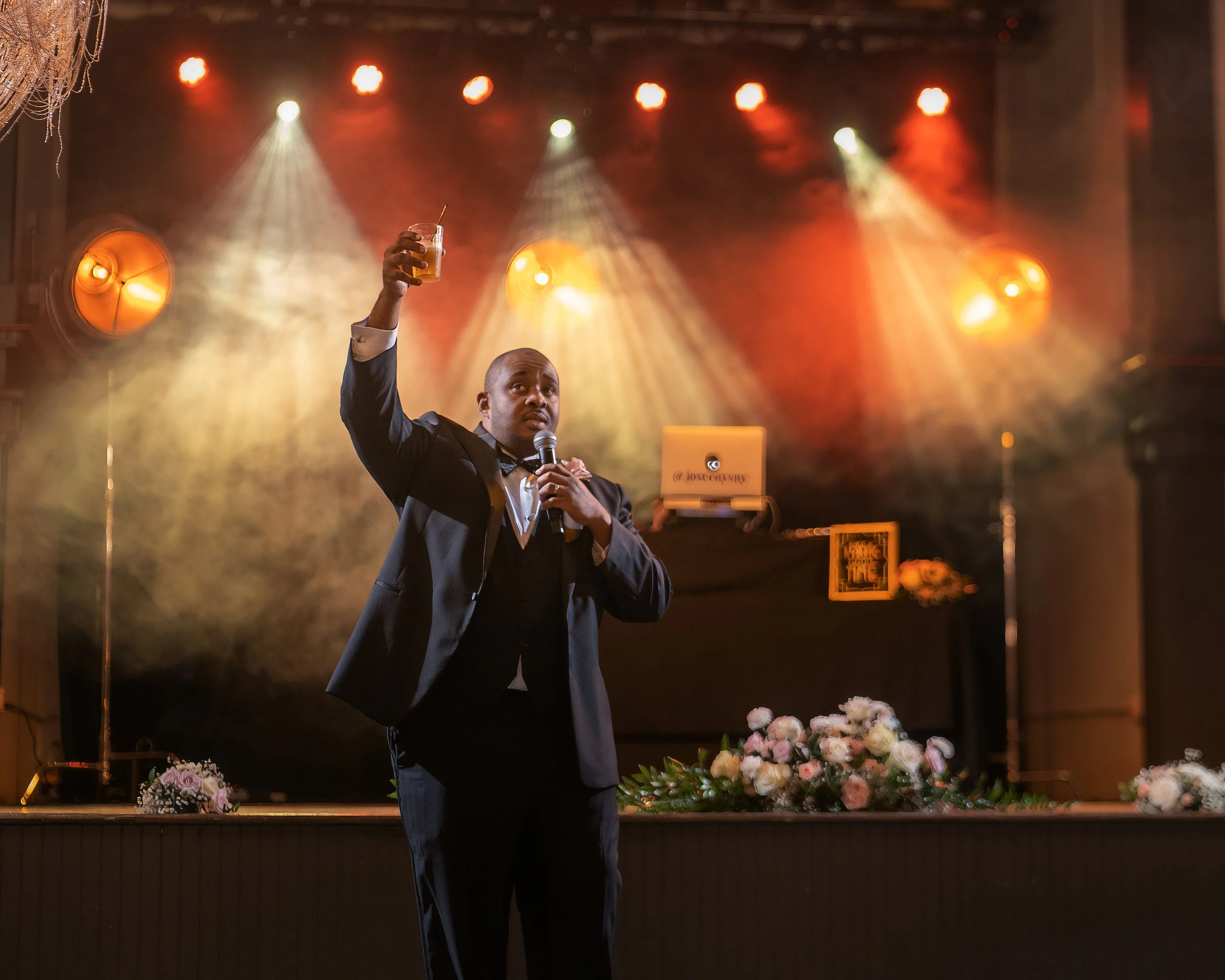 Best man giving a toast beneath the stage during a wedding reception at Victory North in Savannah.