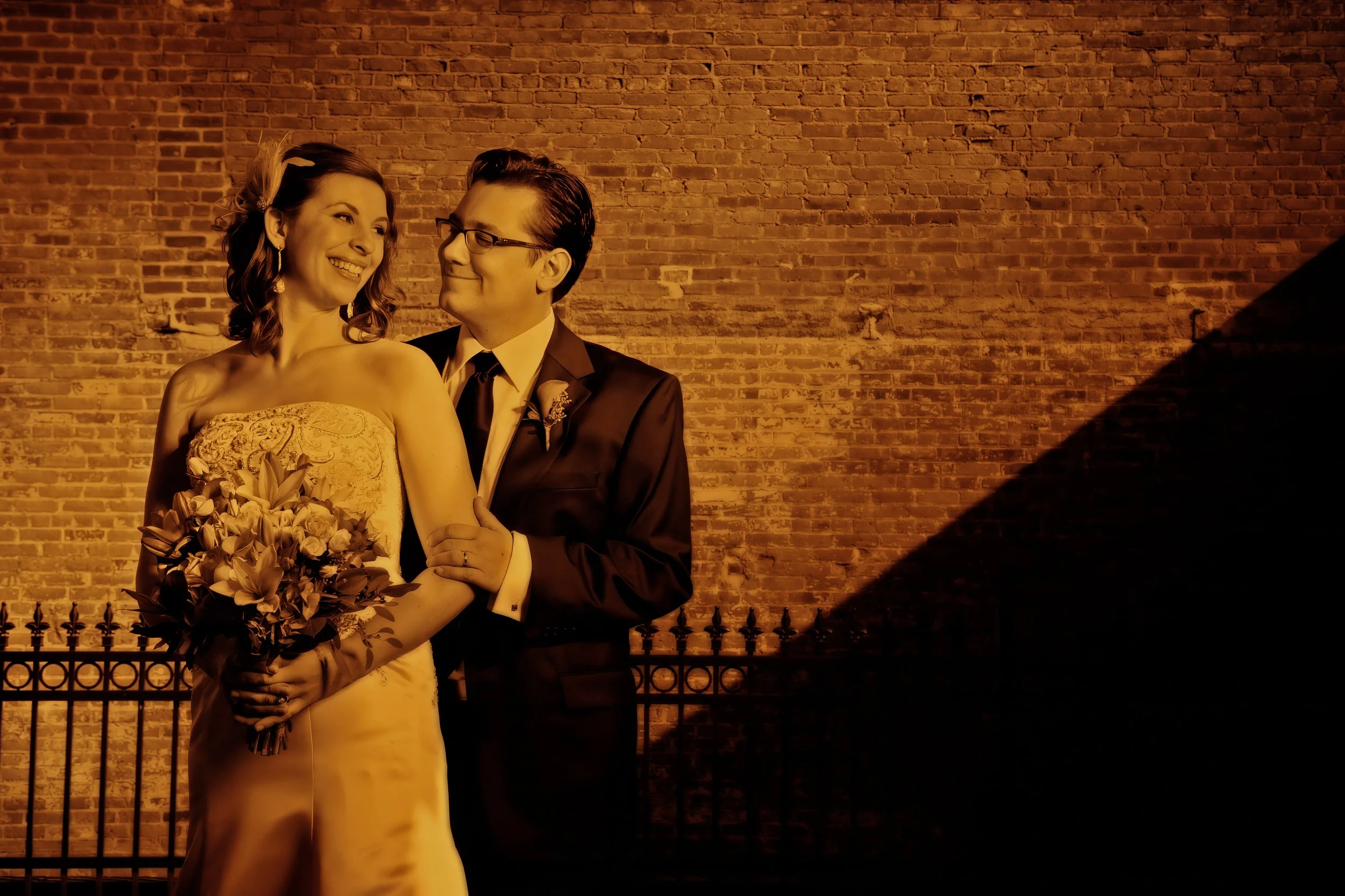 Bride and groom pose in the alley adjacent to Union League Cafe in Downtown New Haven, Connecticut, in a fine art portrait.