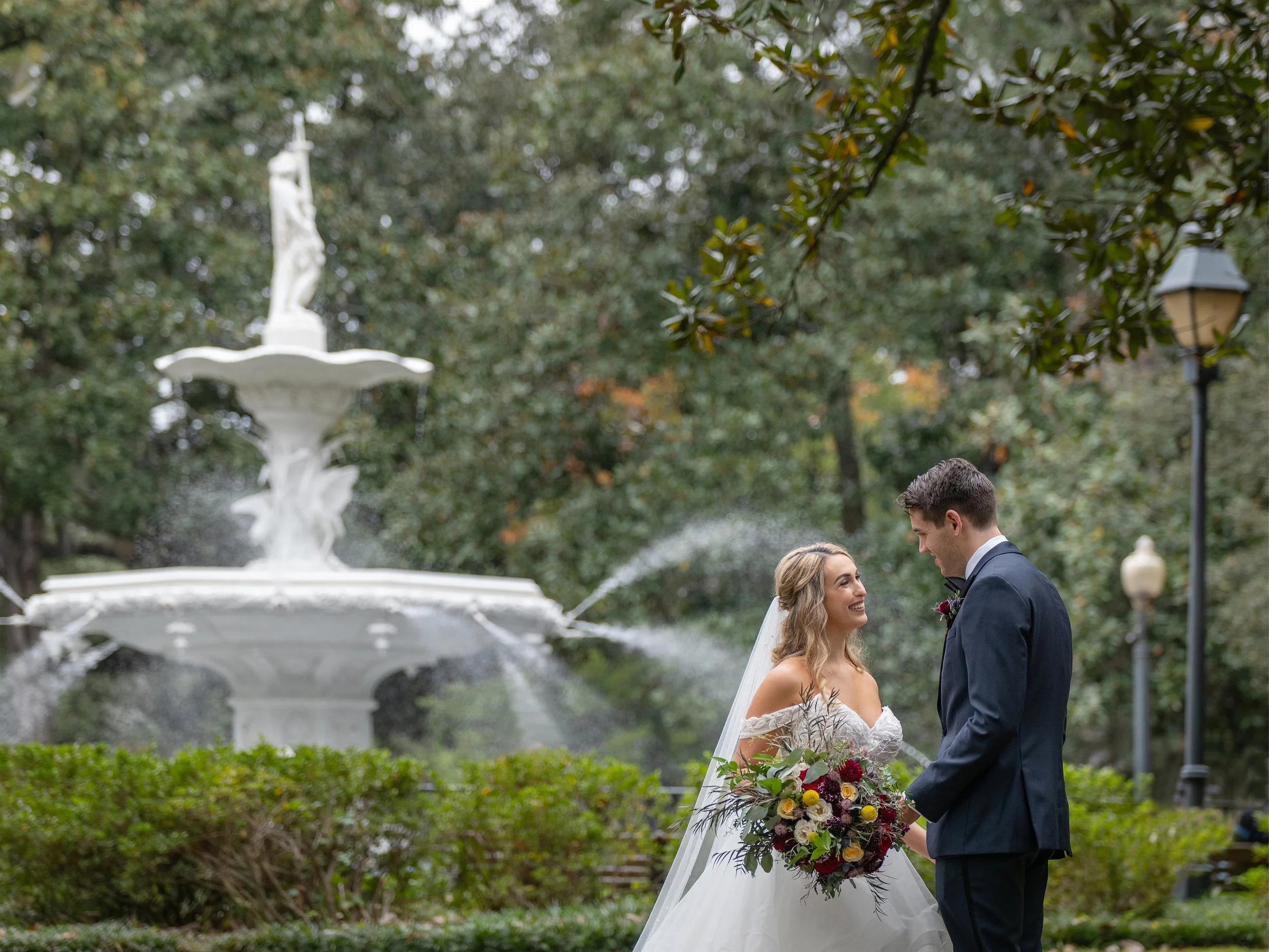 Savannah elopement packages couple at Forsyth Park fountain sharing a romantic moment