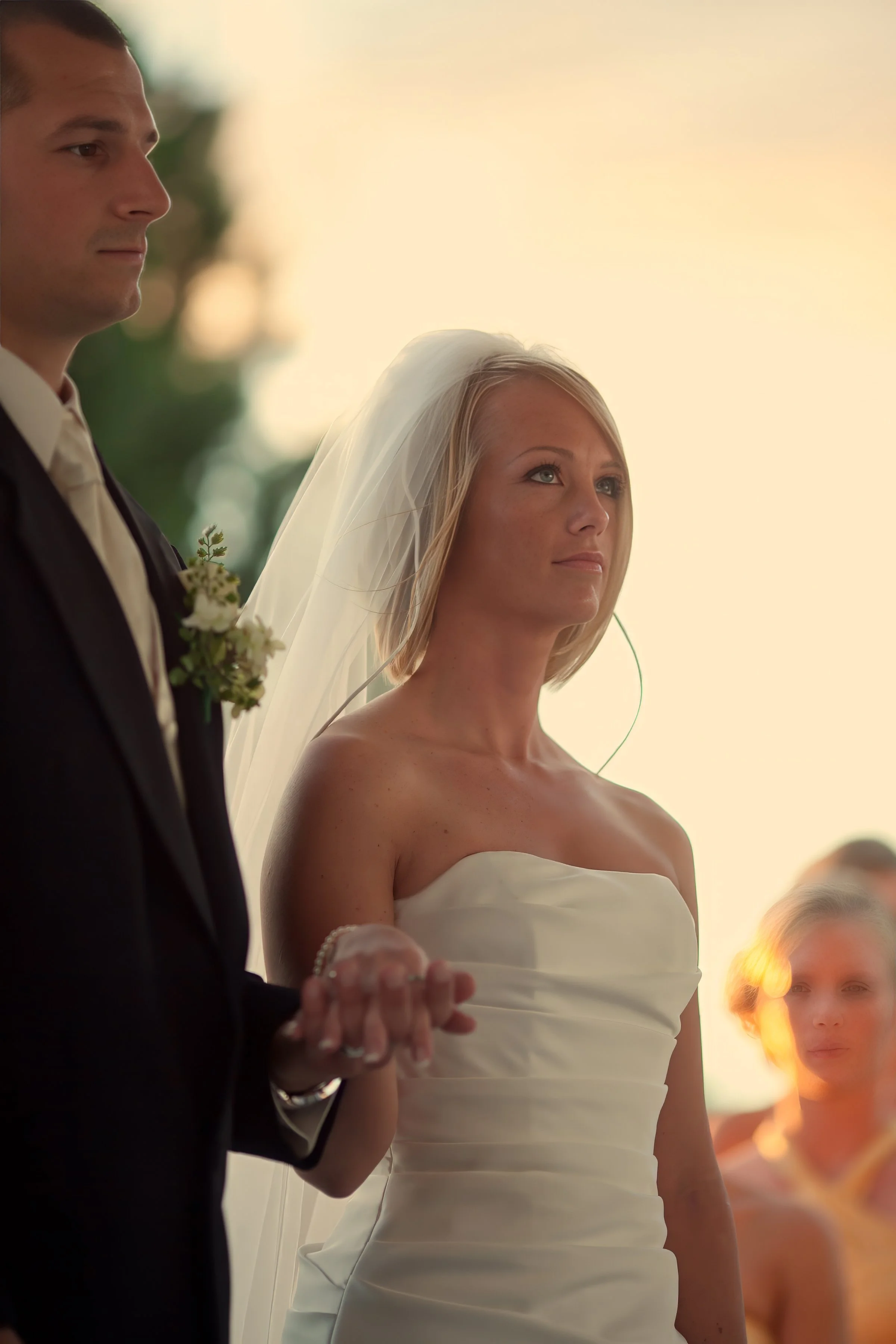Bride and groom hold hands during their wedding ceremony at Amarante’s Sea Cliff in New Haven CT