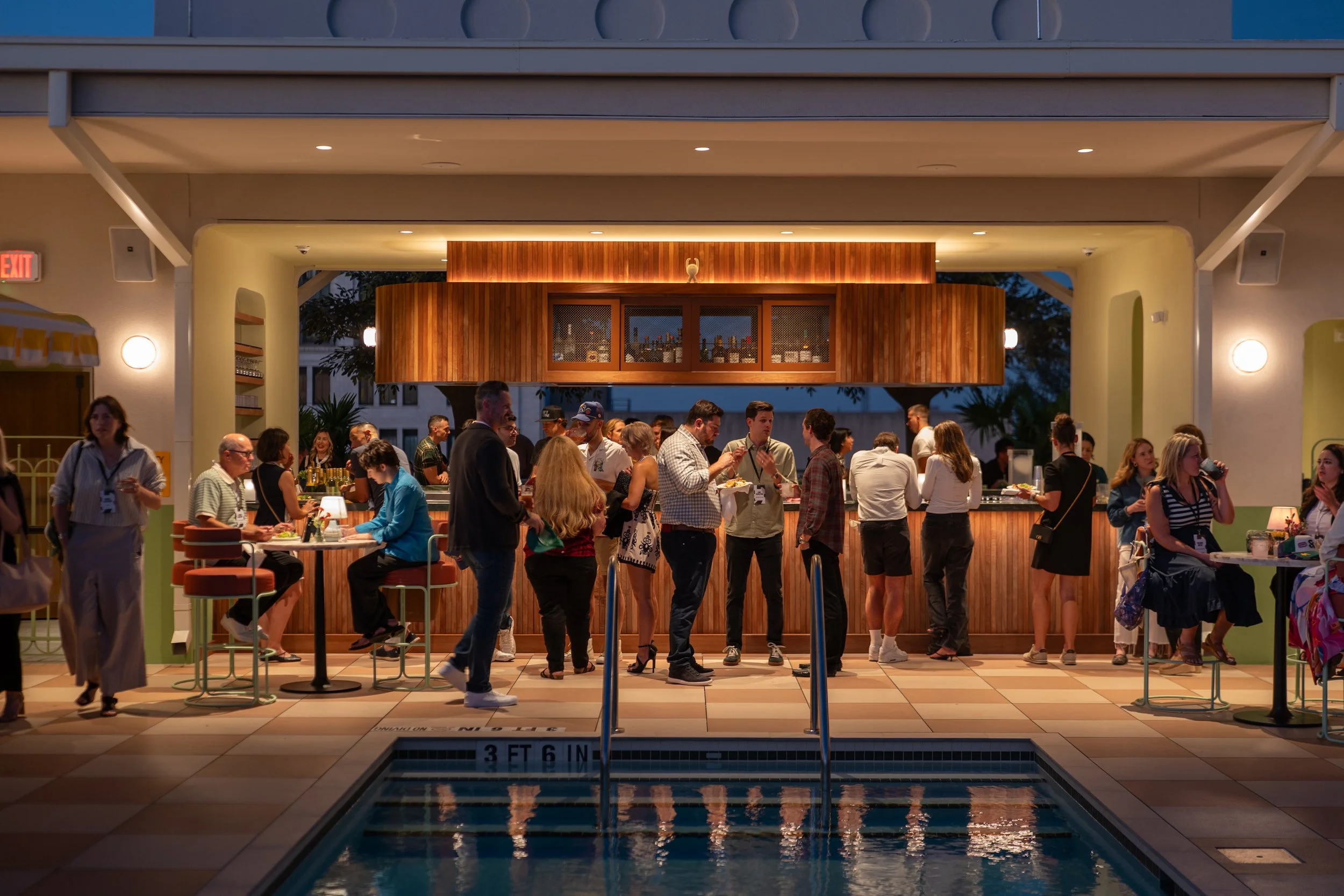 Corporate event guests gathered around the rooftop pool at Recess Hotel & Club in Savannah.