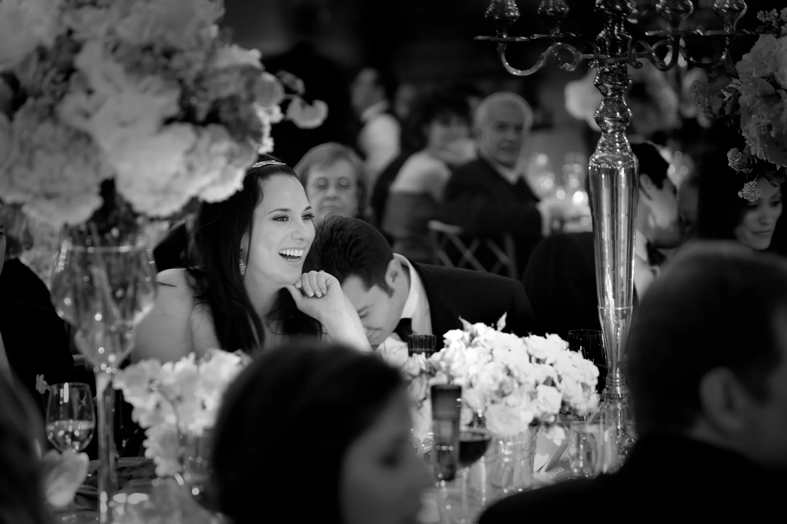 Joyful Bride and Groom at Their Dinner Table