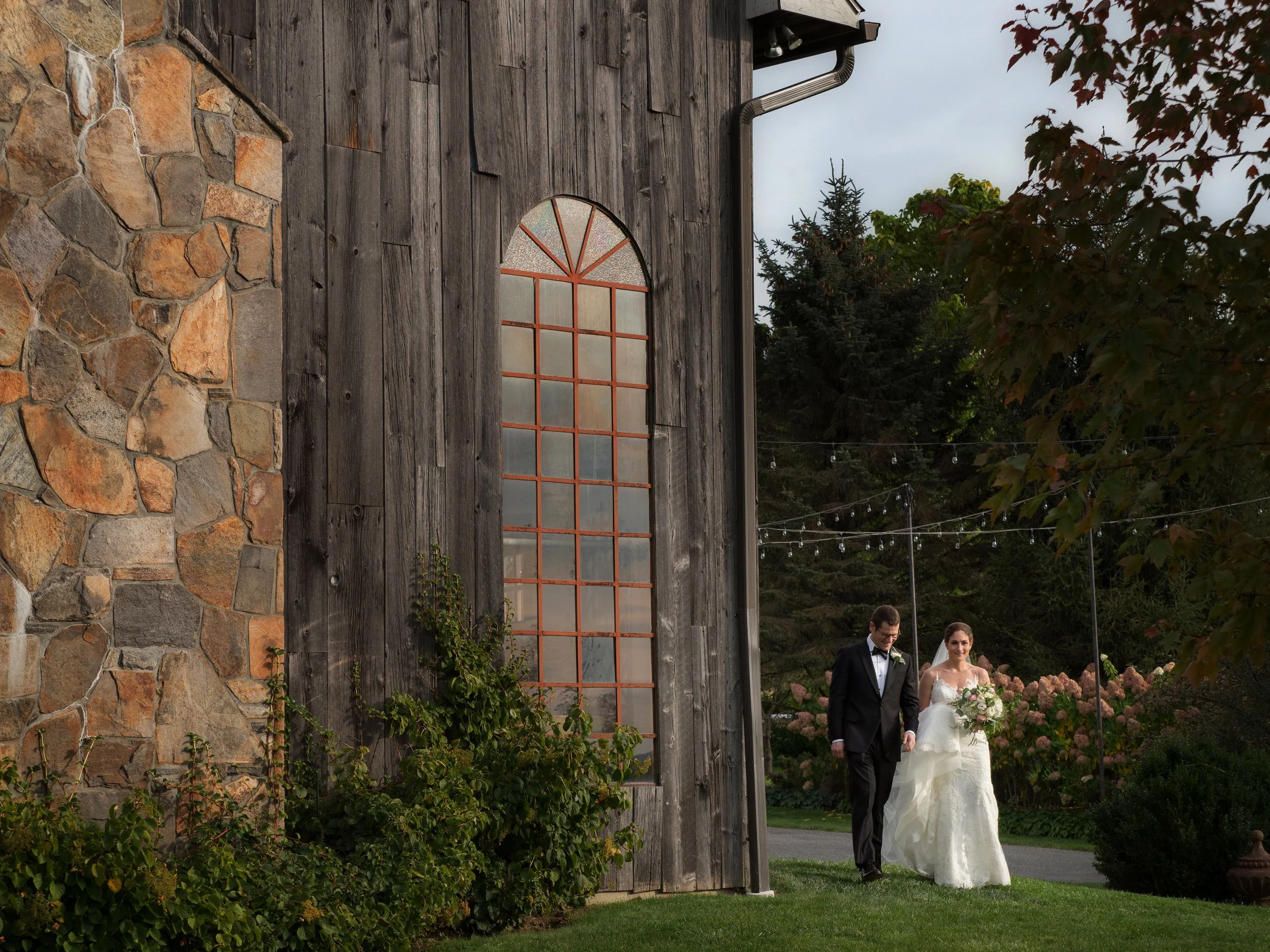 Bride and groom walk the grounds near the barn at Lion Rock Farm, Litchfield, Connecticut