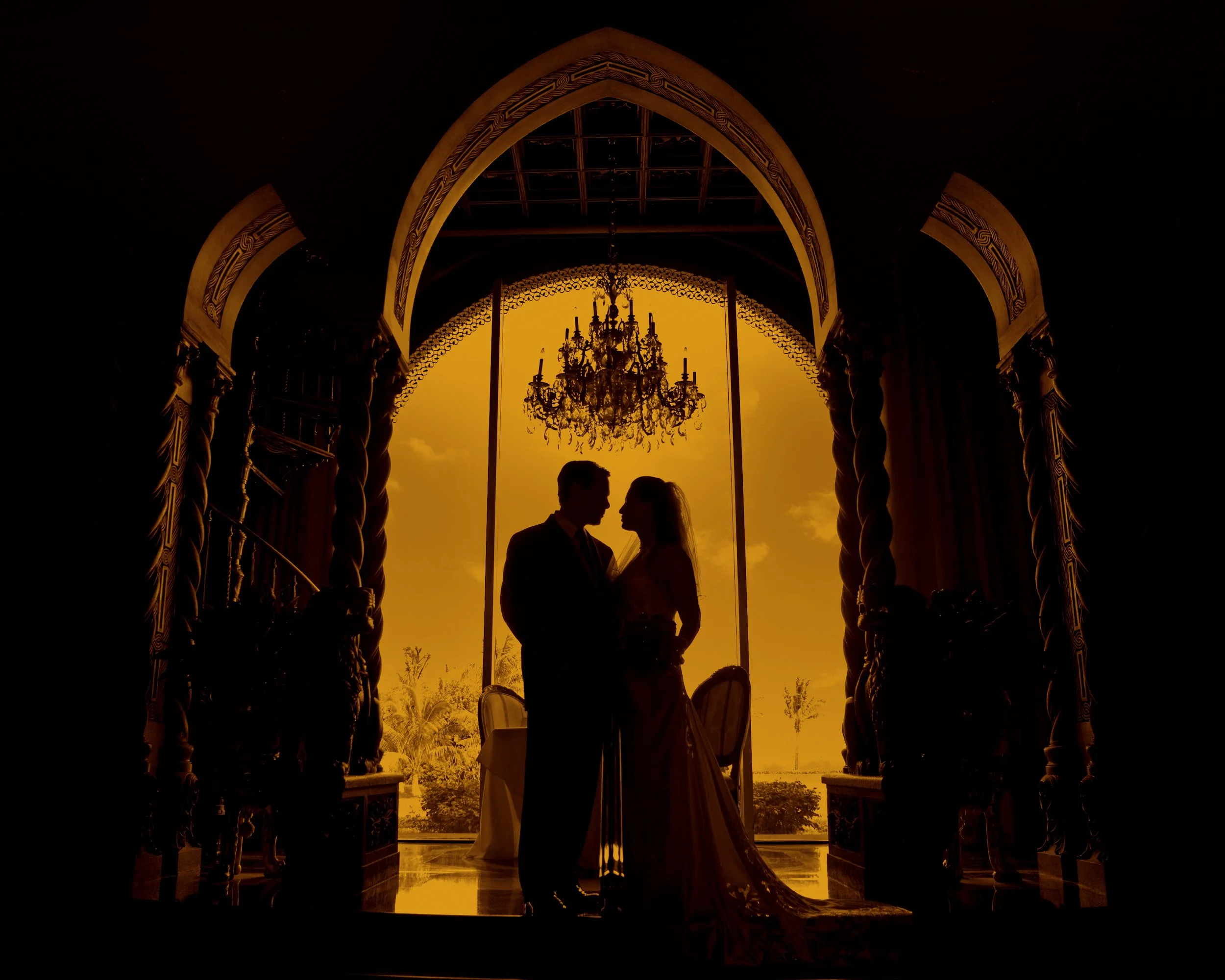 Bride and groom framed in the archways at a Mar-a-Lago Club Wedding
