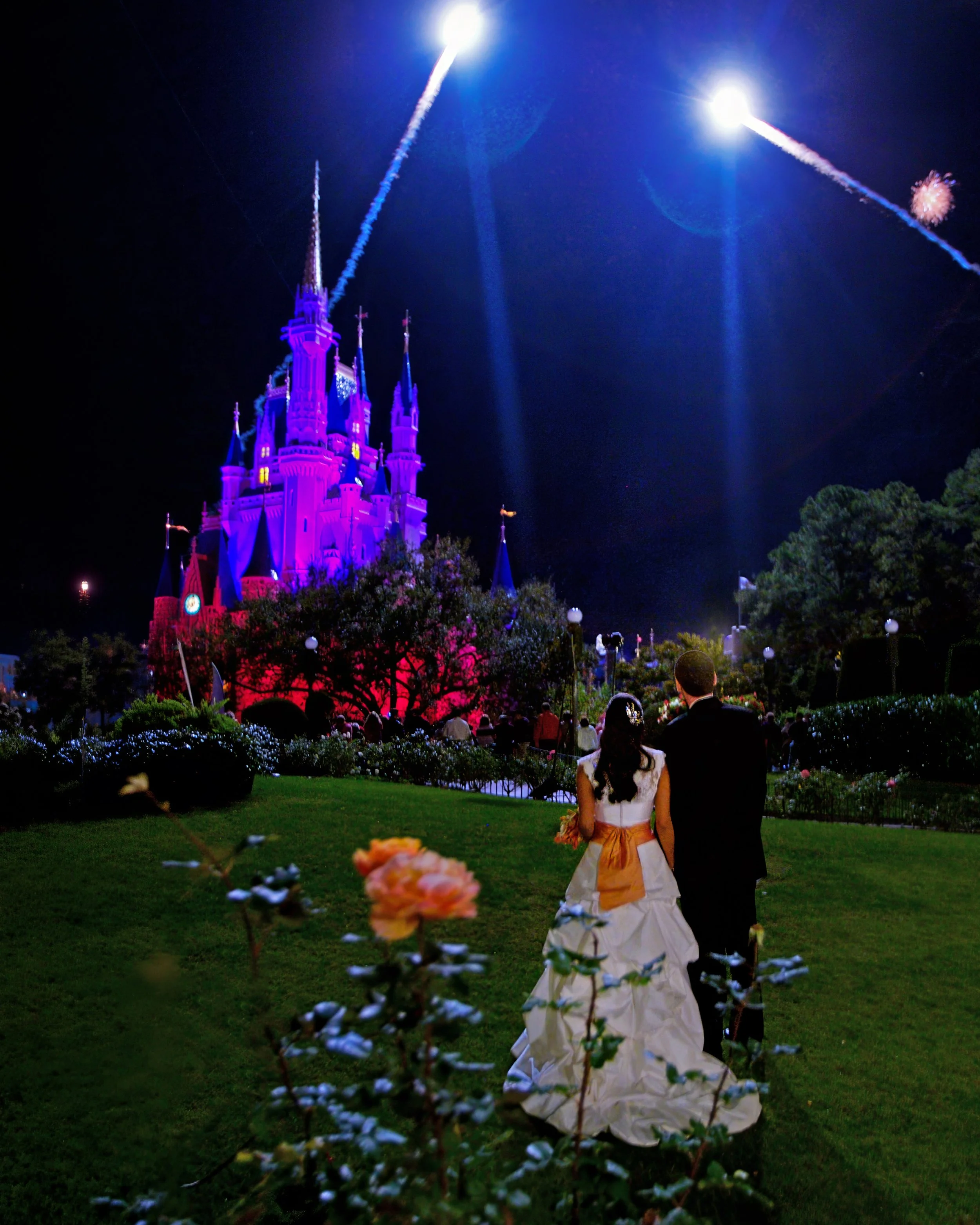 Bride and groom watch fireworks over Cinderella Castle during their Disney Dream Wedding reception.