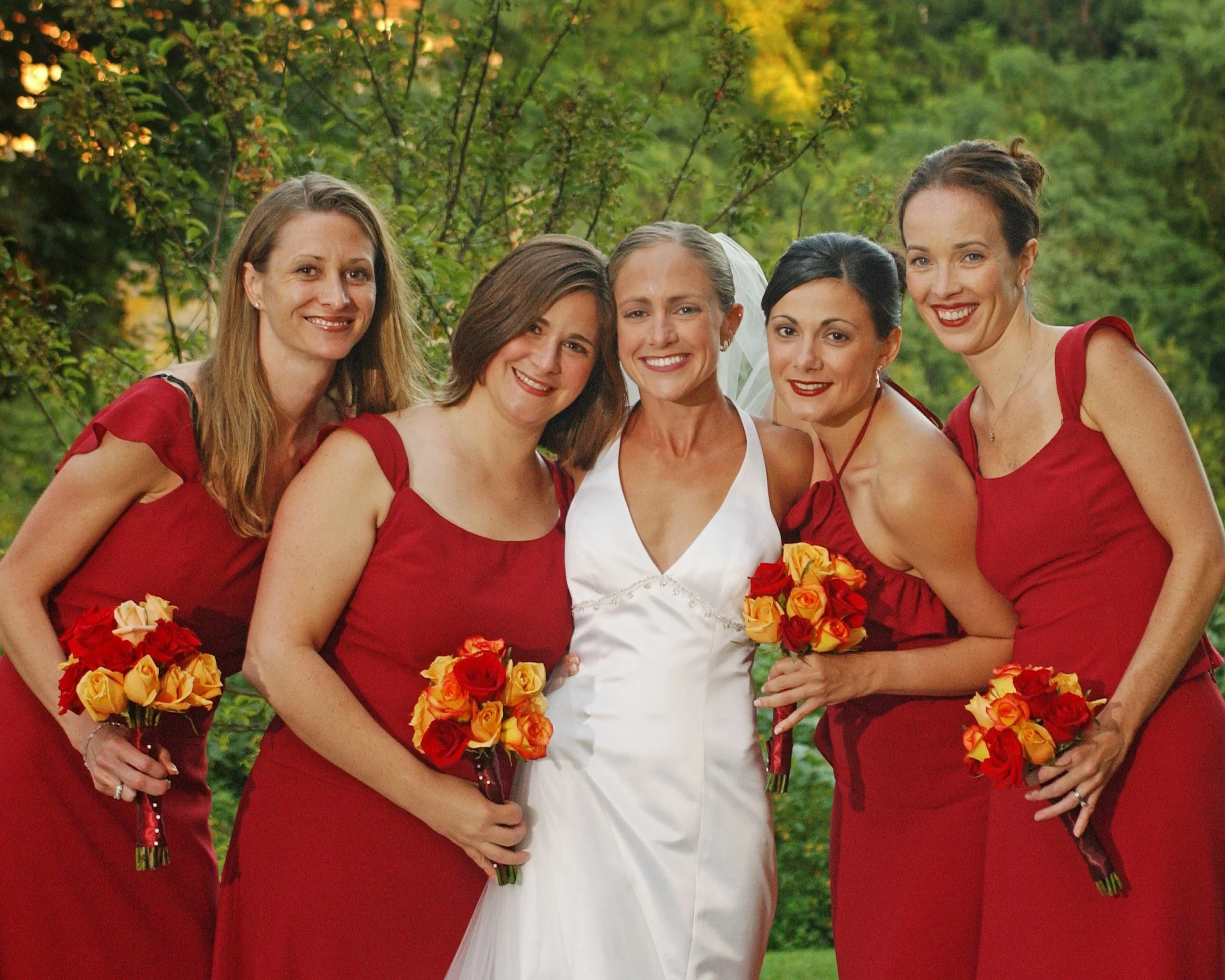 Bridesmaids embrace in a casual, joyful portrait at Castle Hill wedding.