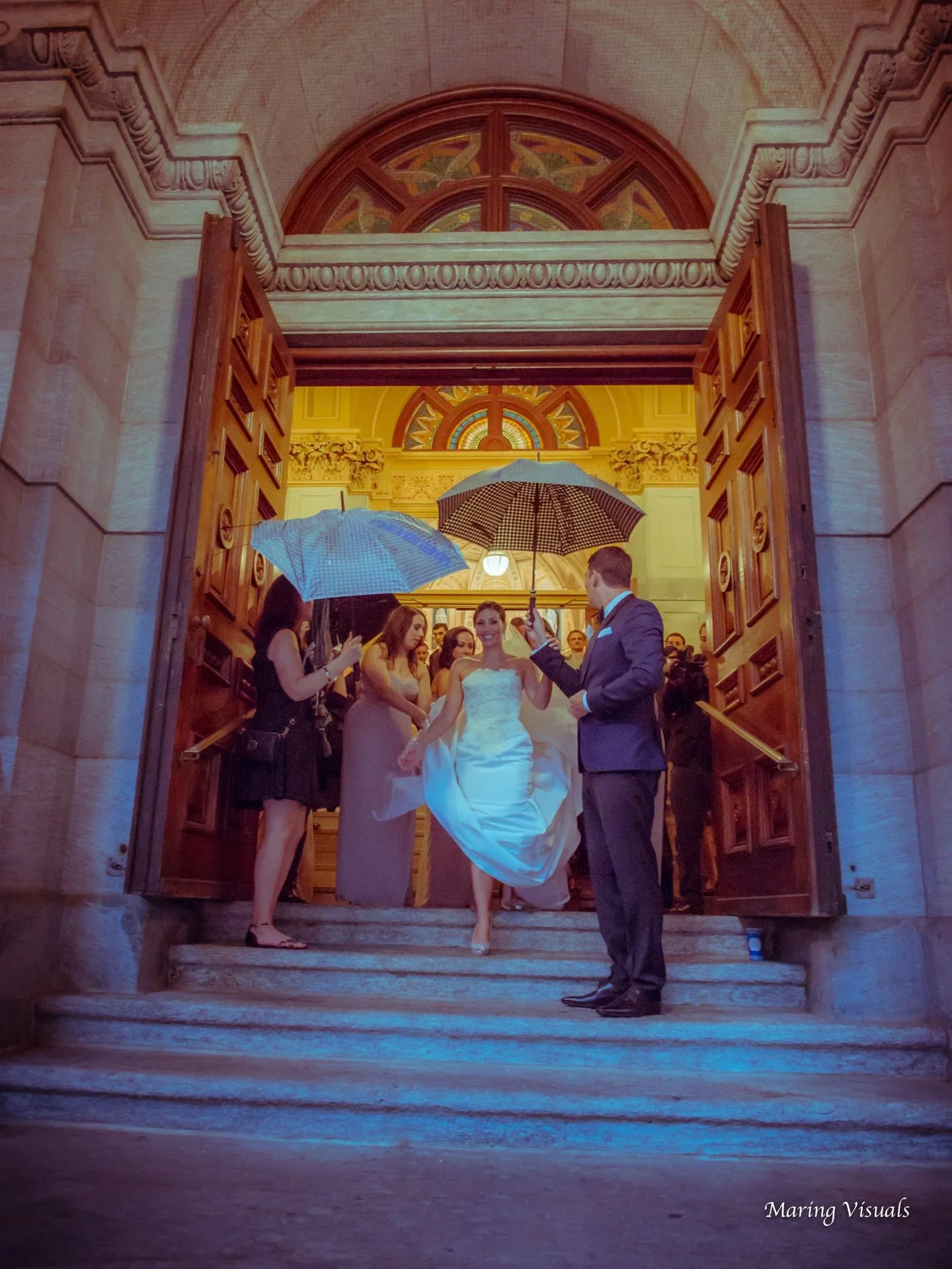 The bride exits St. Francis Xavier Church after her wedding ceremony in NYC