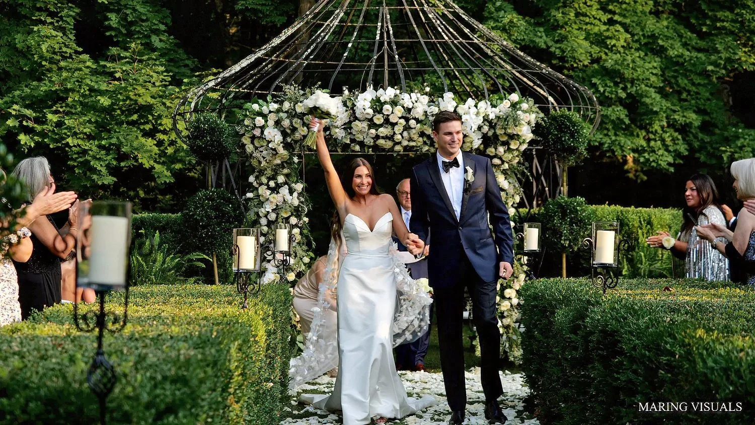 Bride and groom celebrating down ceremony aisle at Lord Thompson Manor wedding in Connecticut