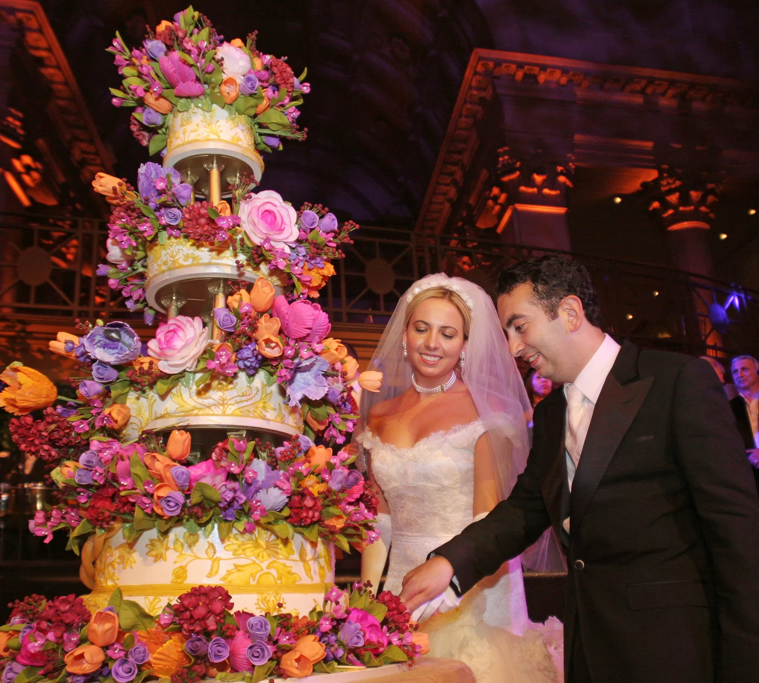 Bride and groom cutting their wedding cake during an elegant reception at Cipriani Wall Street in New York City.